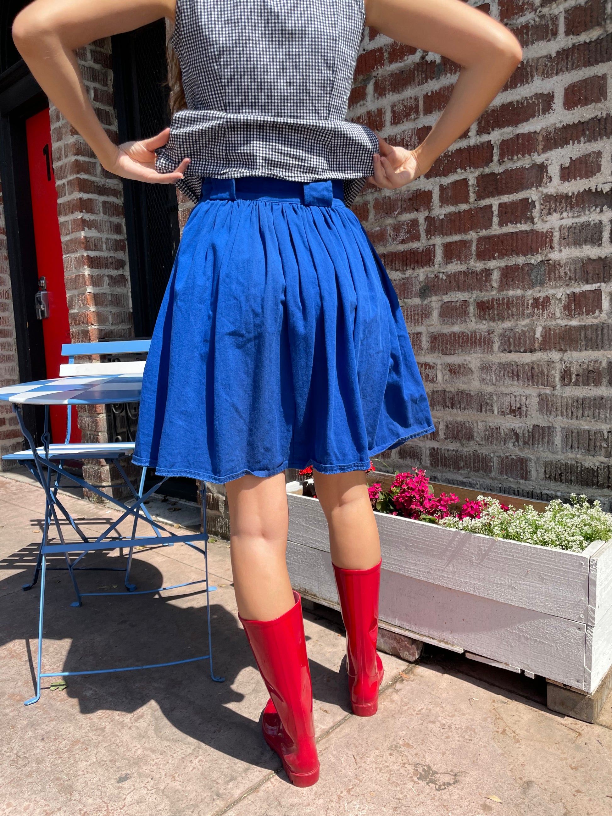 girl in blue skirt and gingham top