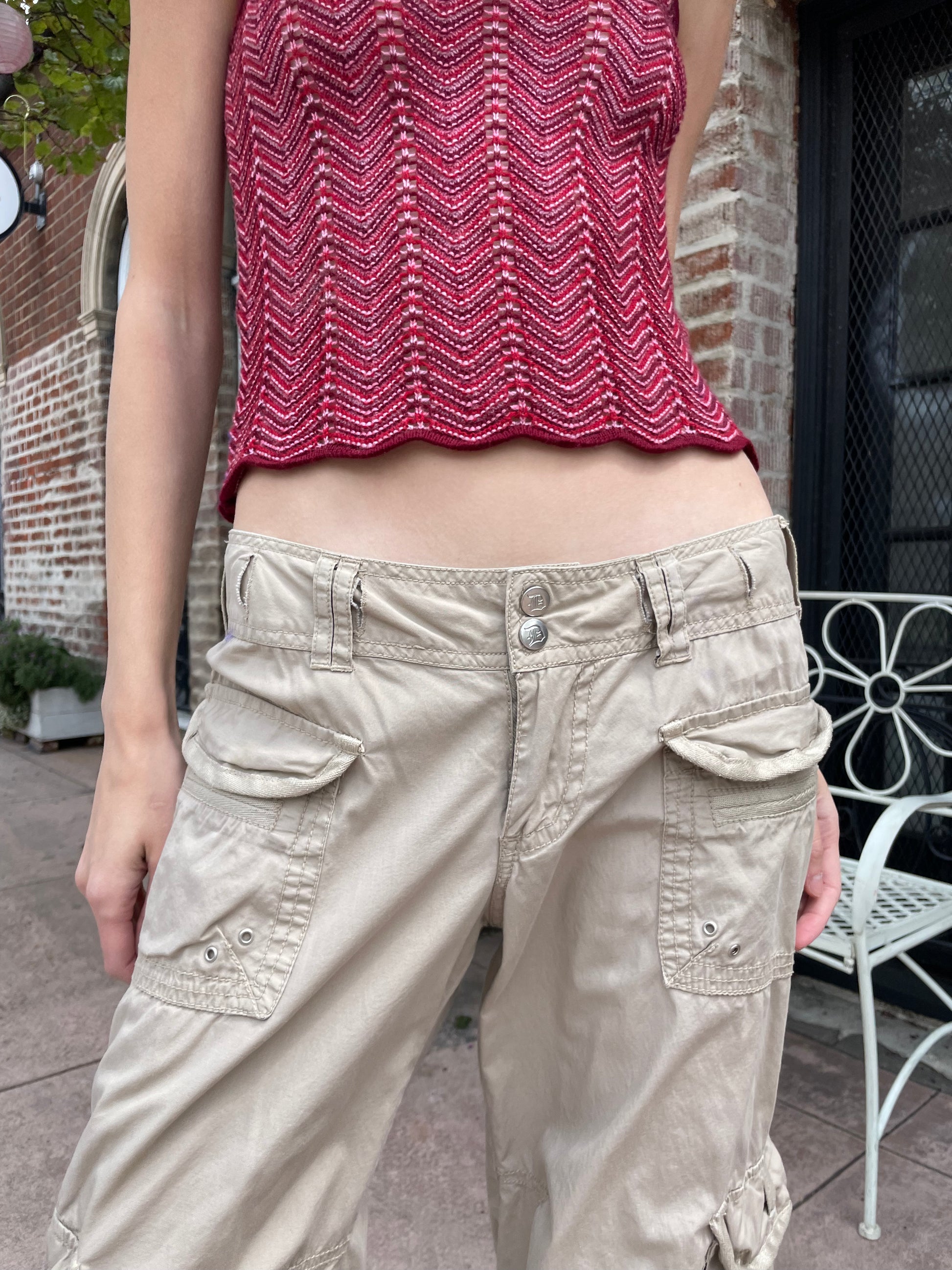 girl wearing red shirt and tan cargo pants