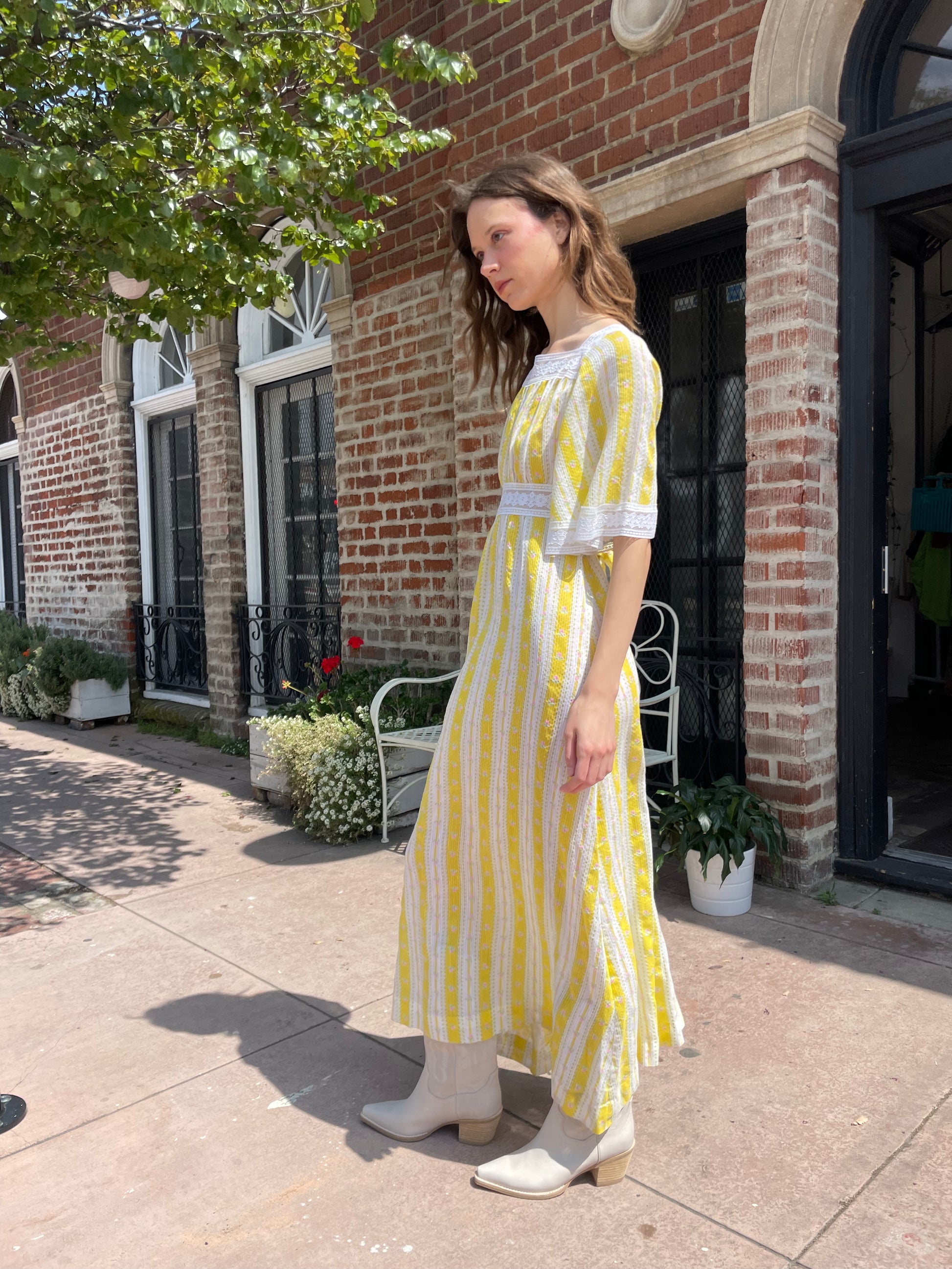 girl wearing long yellow and lace dress