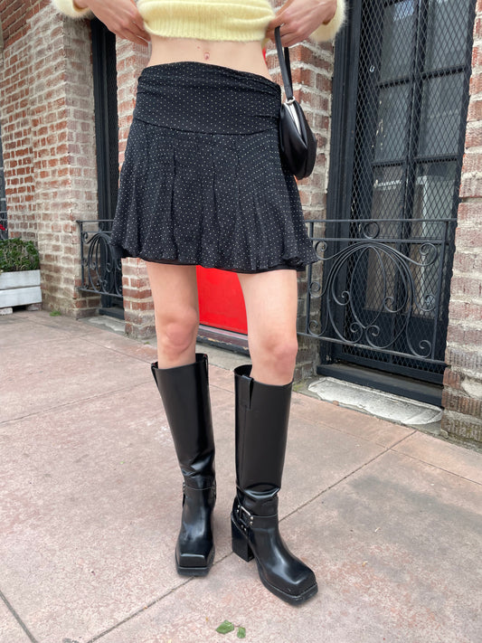 girl wearing yellow sweater and black skirt