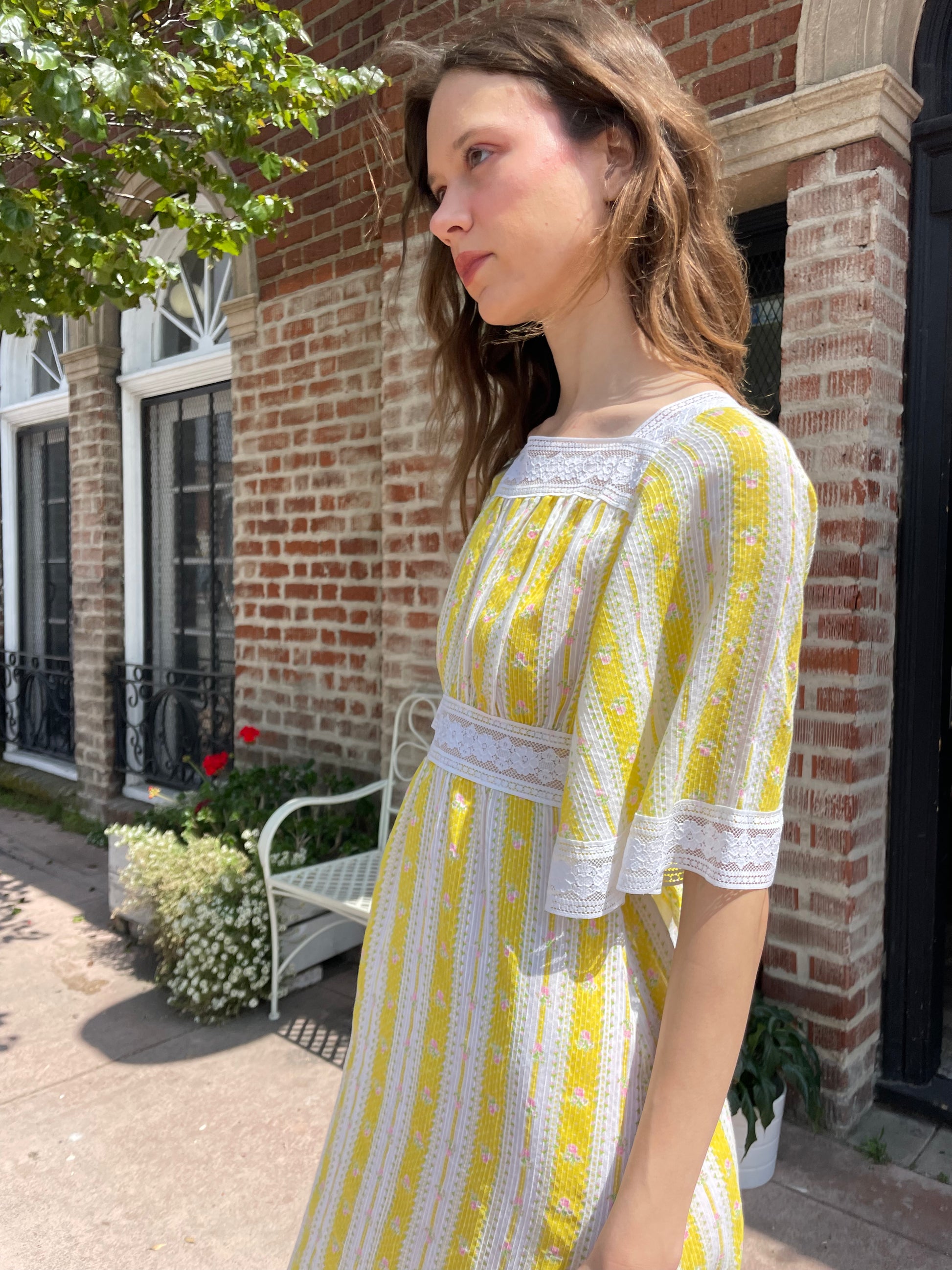 girl wearing long yellow and lace dress