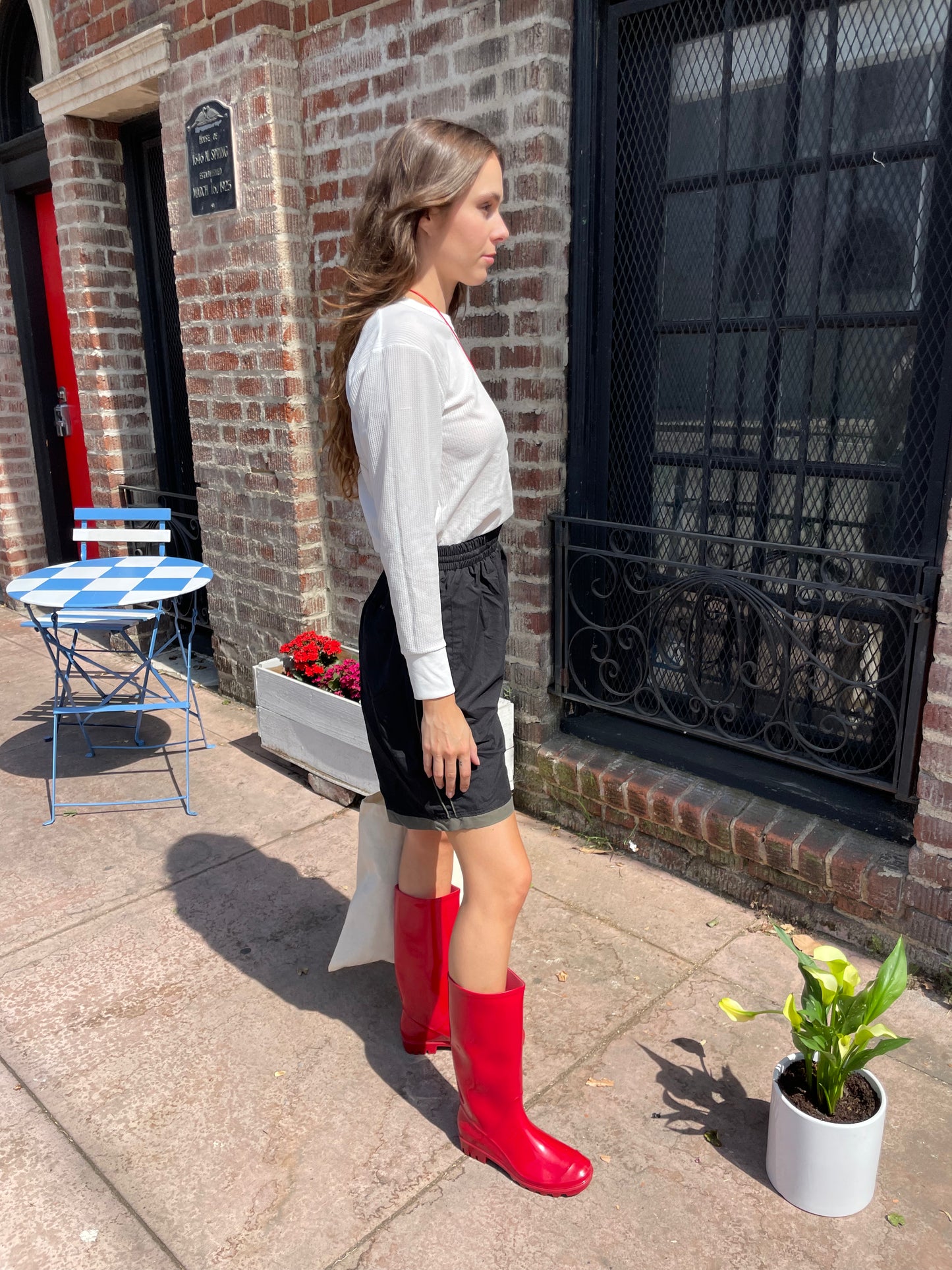 girl in white long sleeve and black shorts