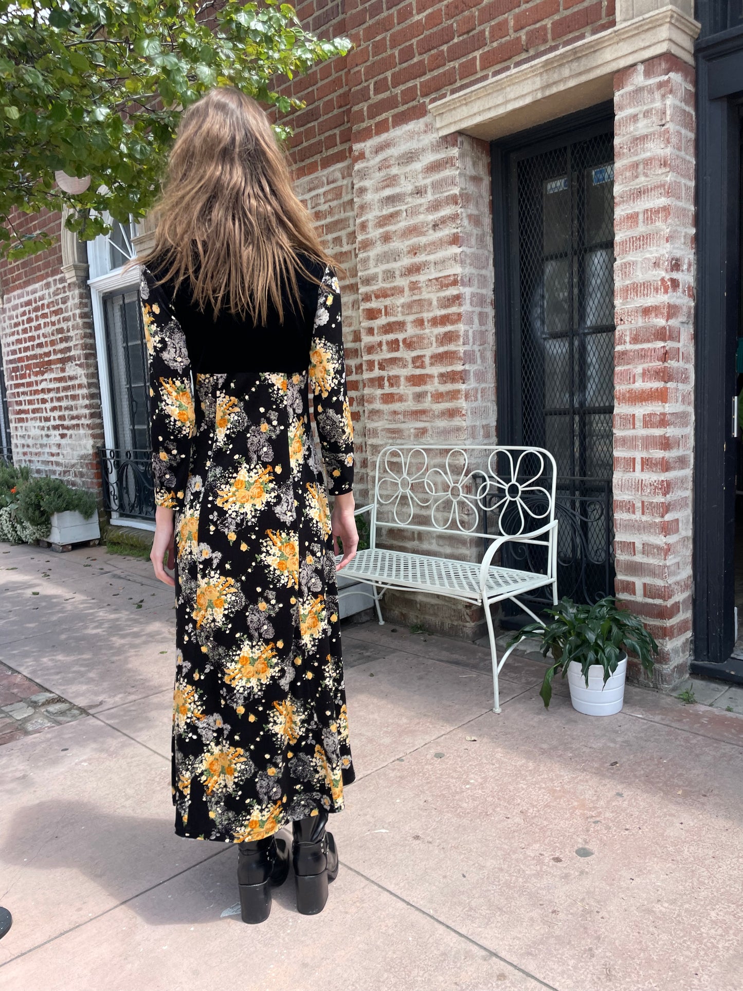 back of girl wearing long sleeve black and yellow dress