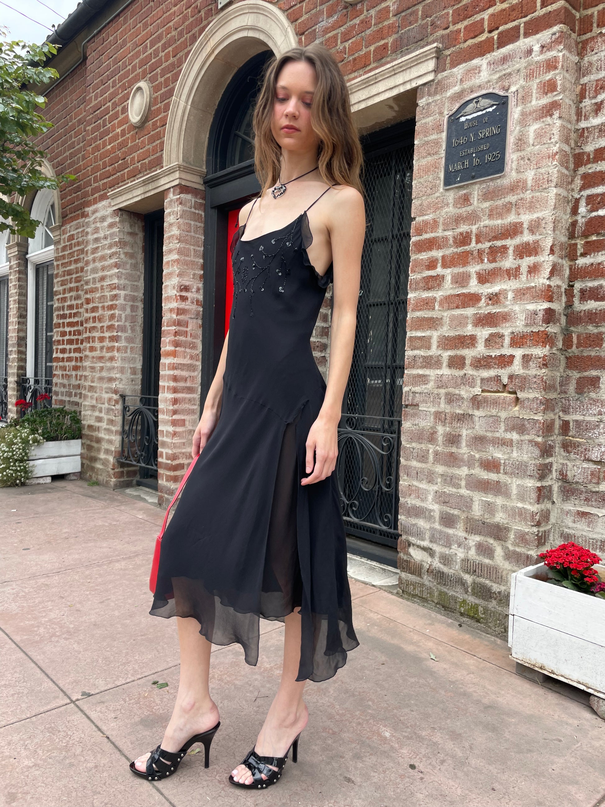 girl in black skinny strap dress