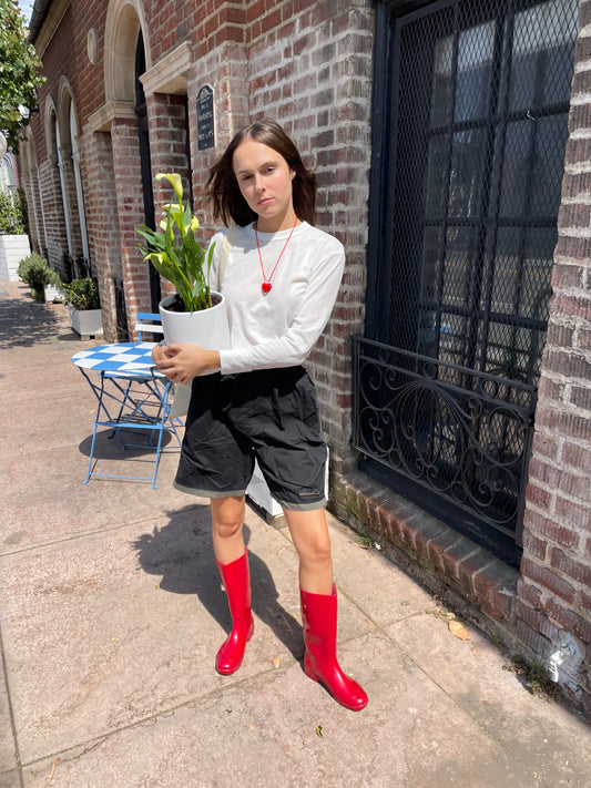 girl in white long sleeve top and black shorts