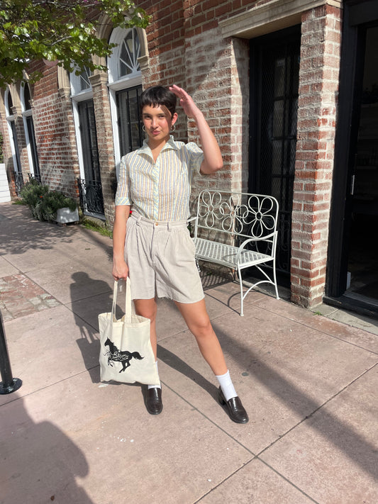 girl wearing tan shirt and shorts