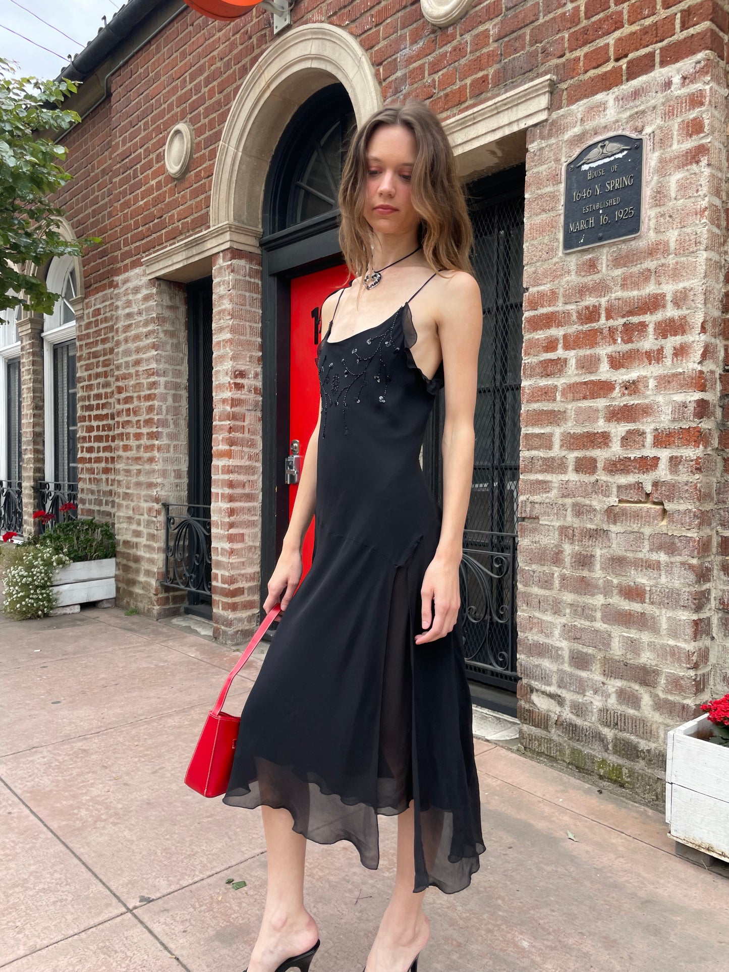 girl in black skinny strap dress