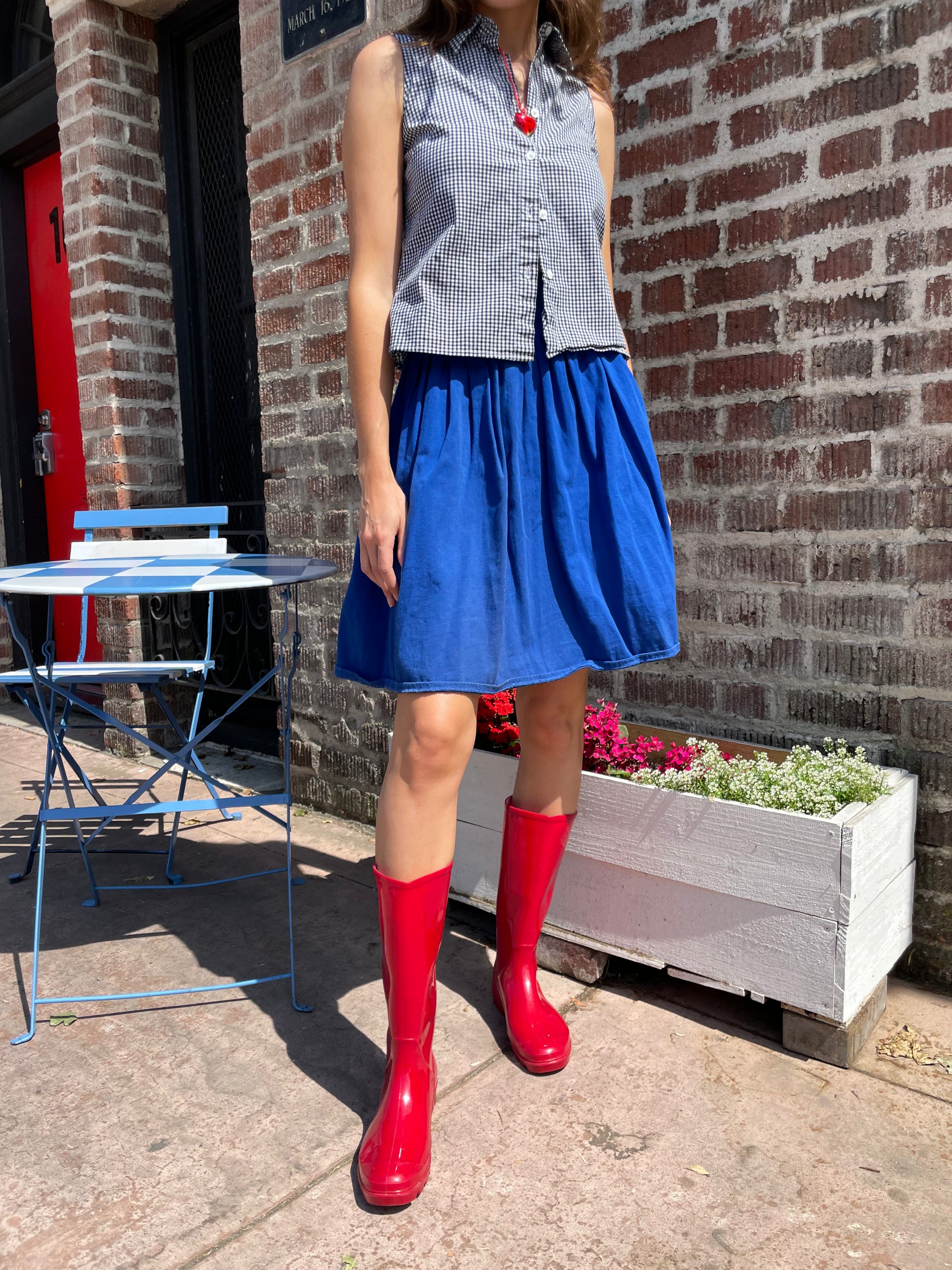 girl in blue skirt and gingham top