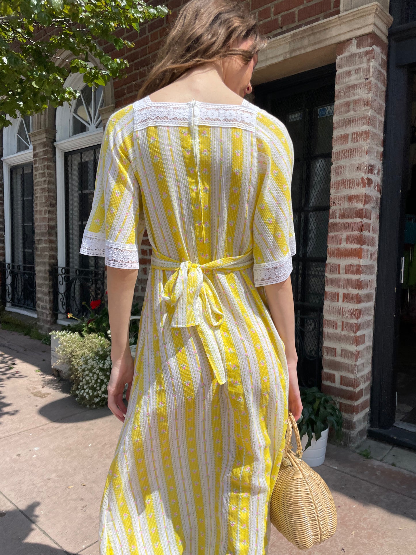 girl wearing long yellow and lace dress