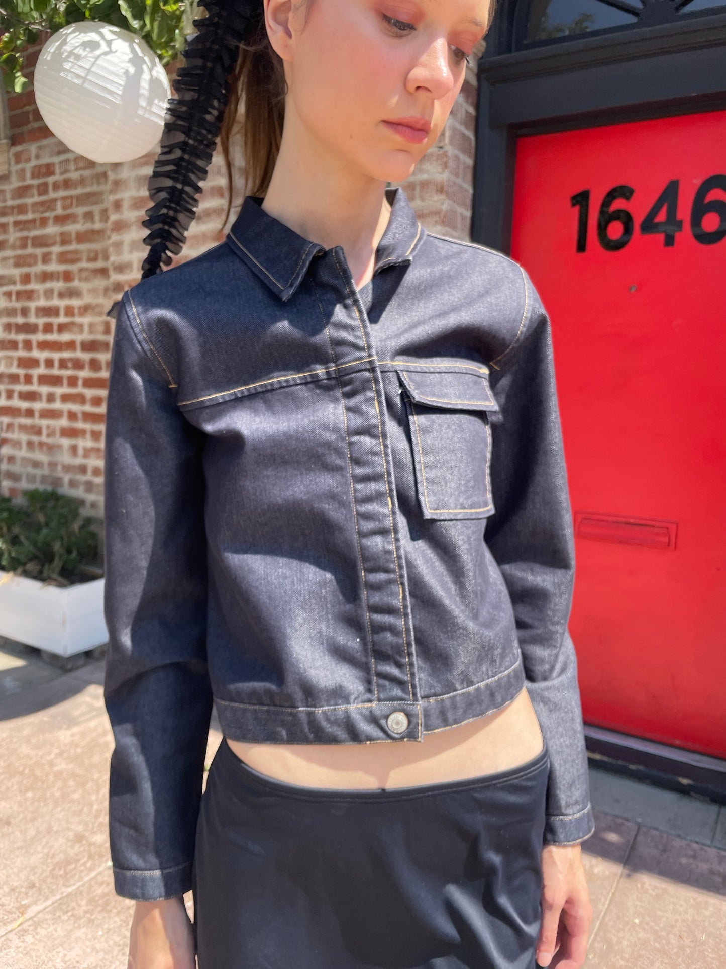 girl in denim jacket, black skirt and leather boots
