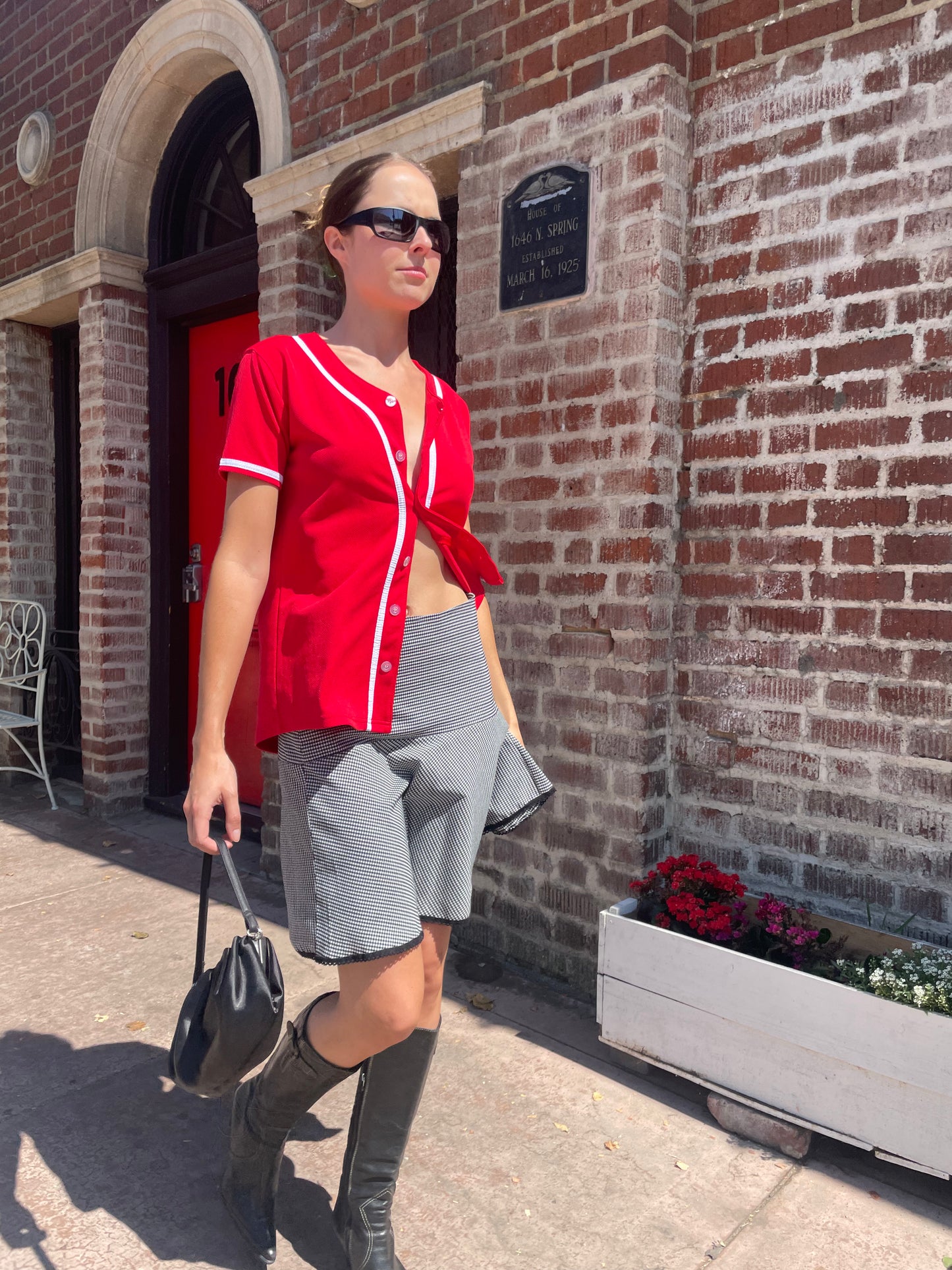 girl in black and white skirt and red top