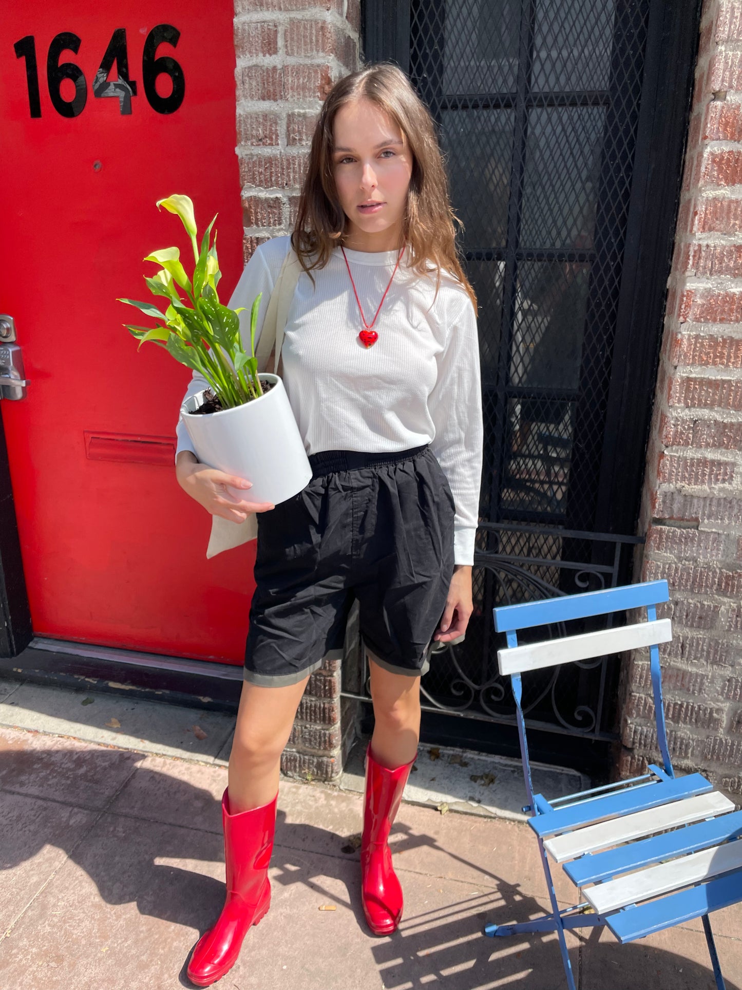 girl in white long sleeve top and black shorts