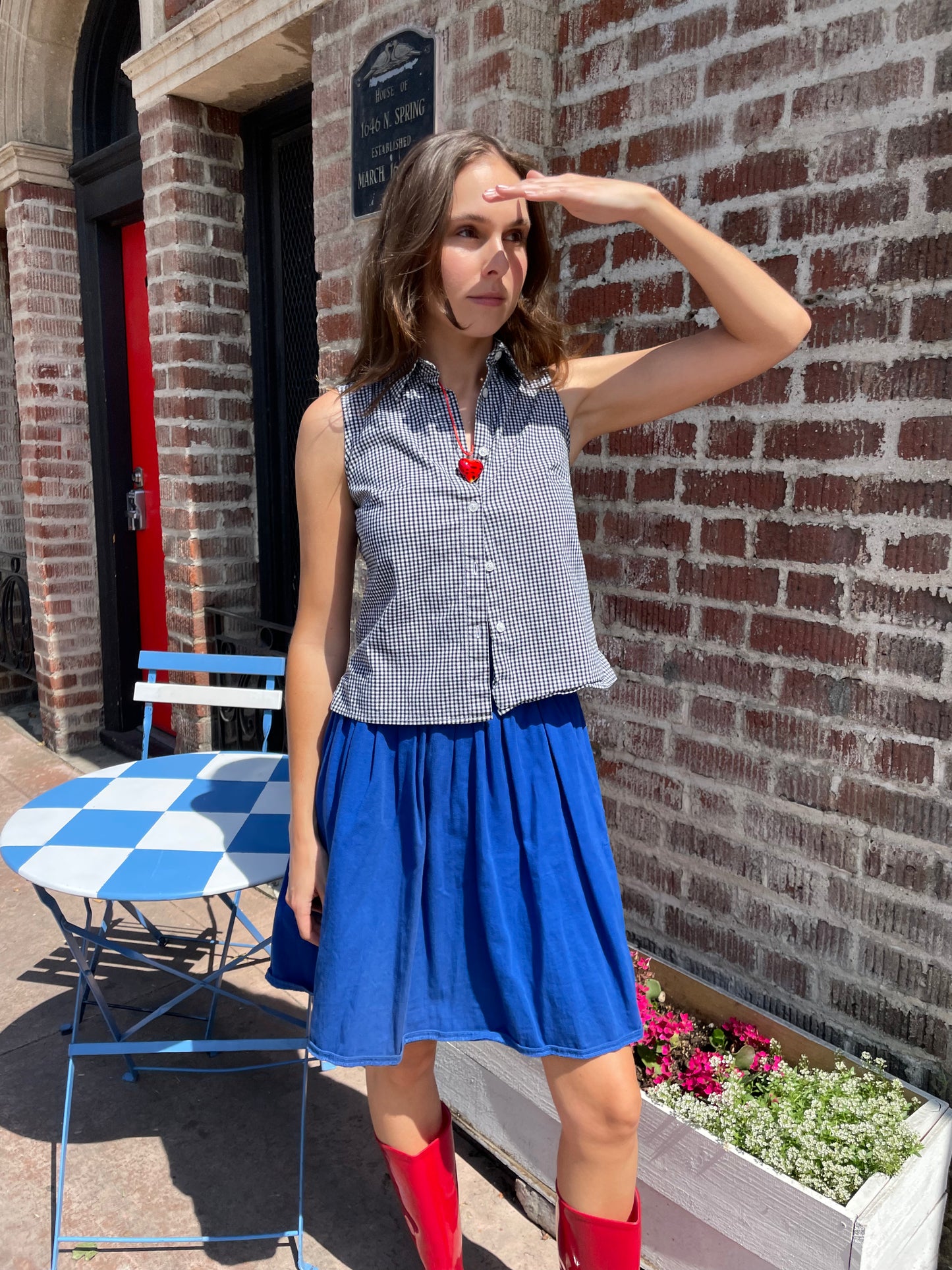 girl in blue skirt and gingham top