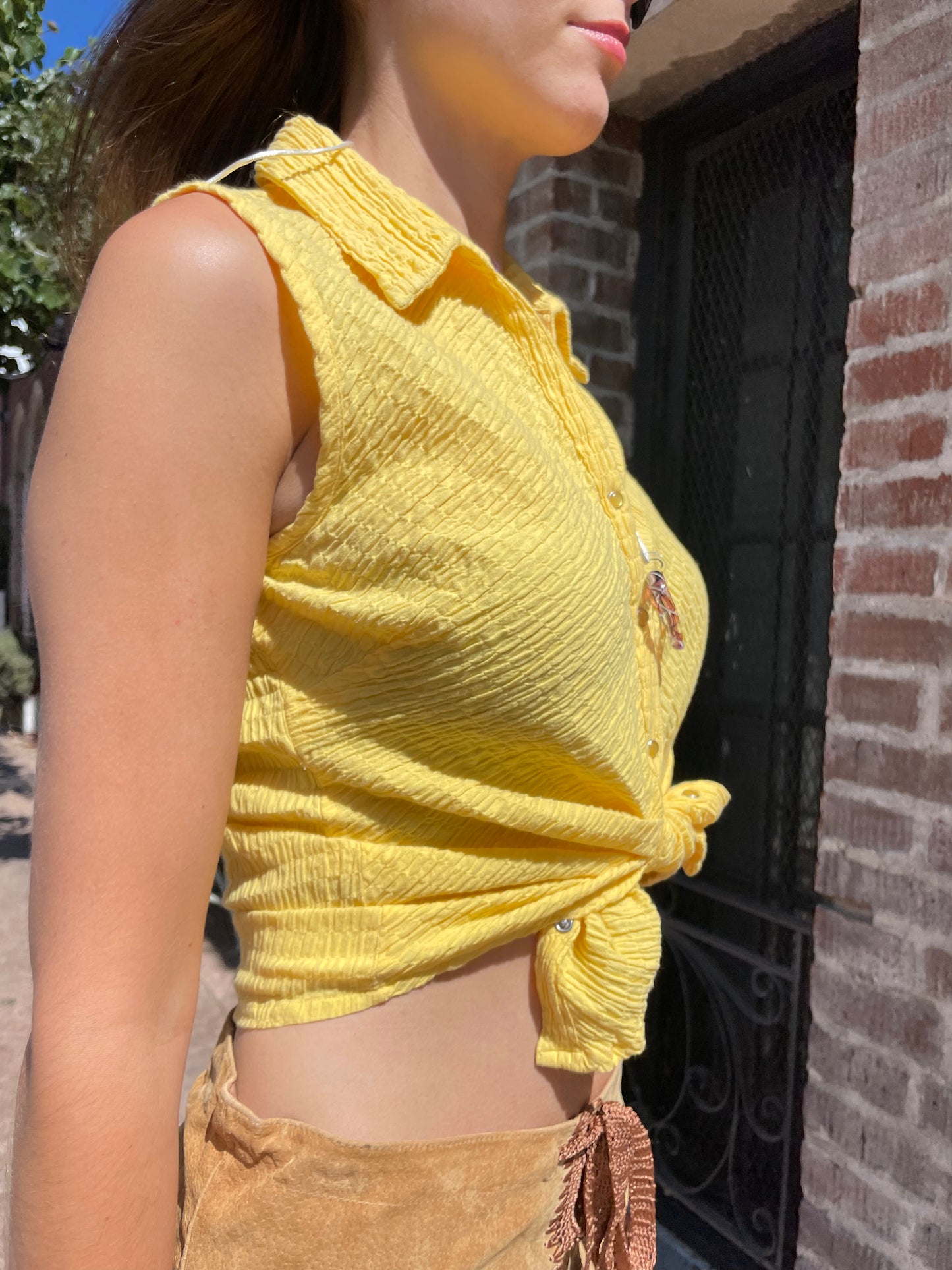 girl in tan leather skirt and yellow top