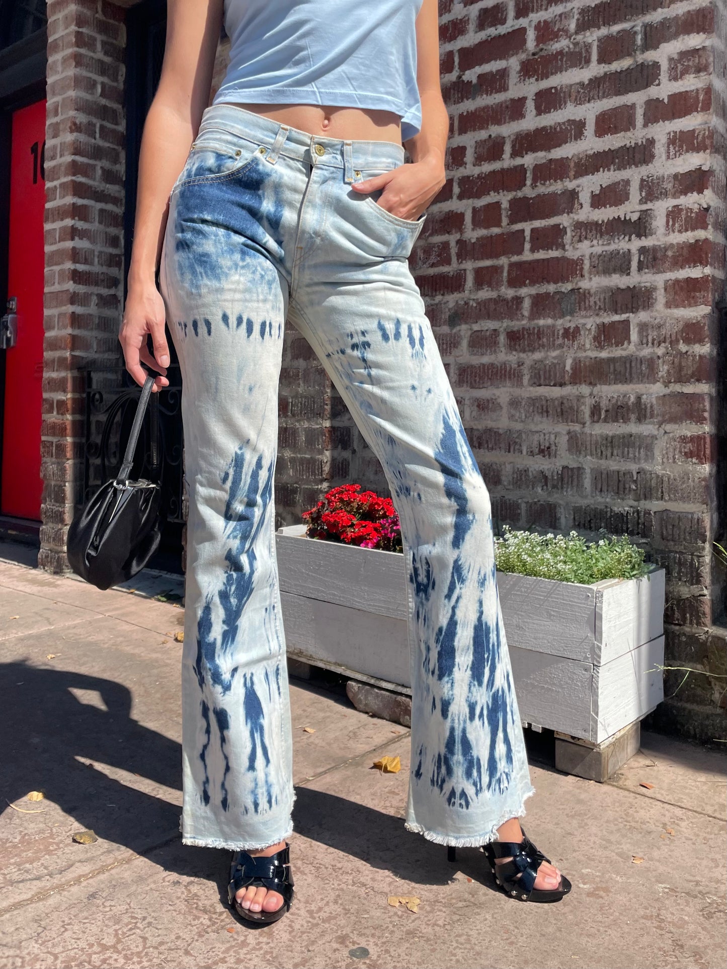 girl wearing flare jeans and blue top