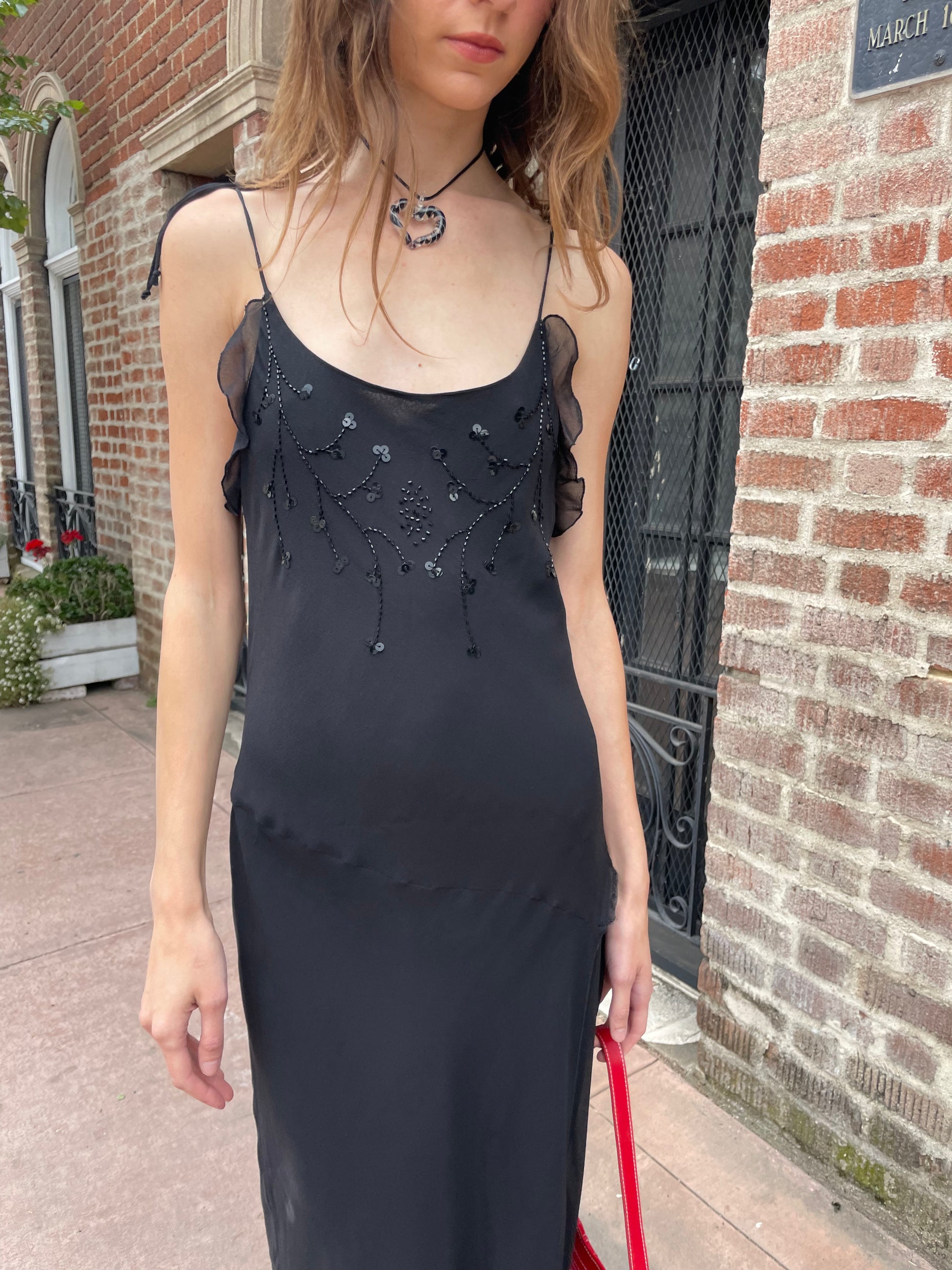 girl in black skinny strap dress