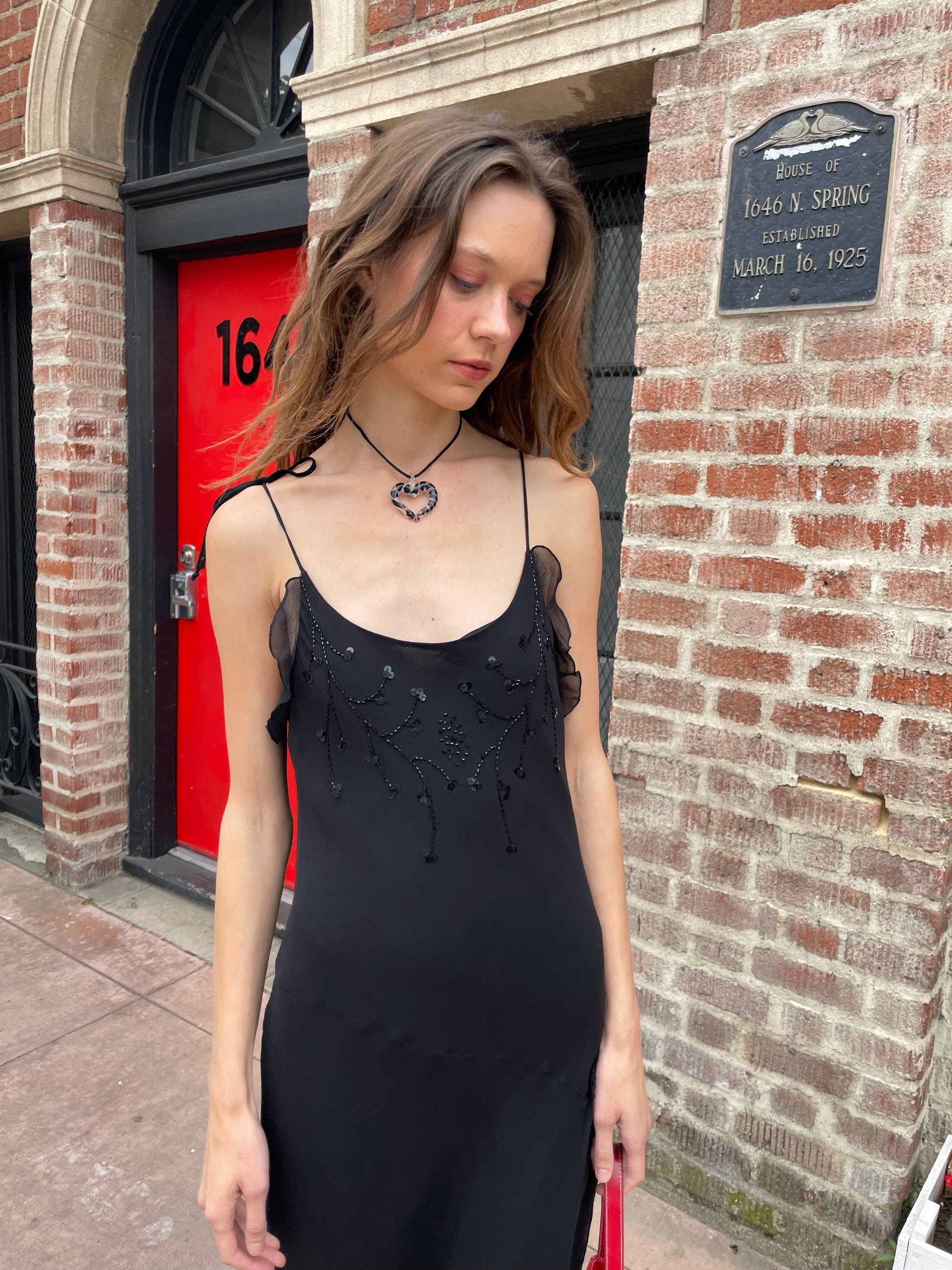 girl in black skinny strap dress
