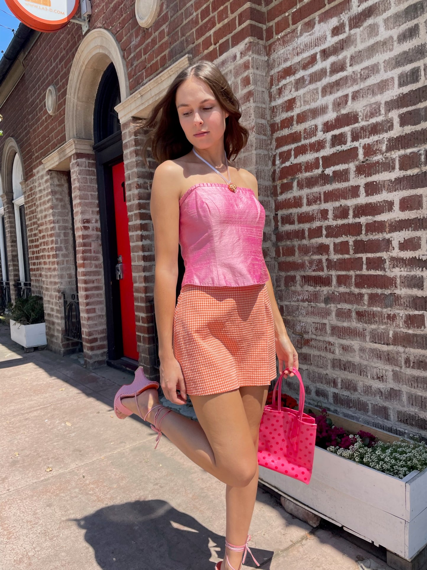 girl in orange shorts and pink strapless top