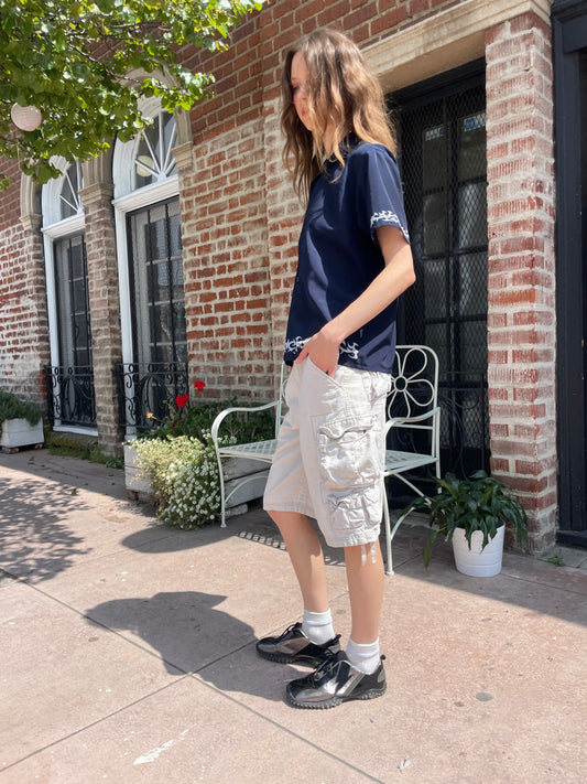 girl wearing blue button up shirt and khaki cargo shorts