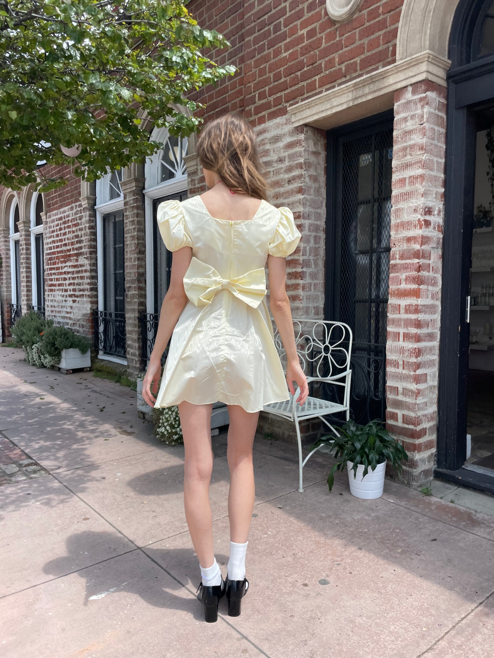 girl wearing yellow short dress