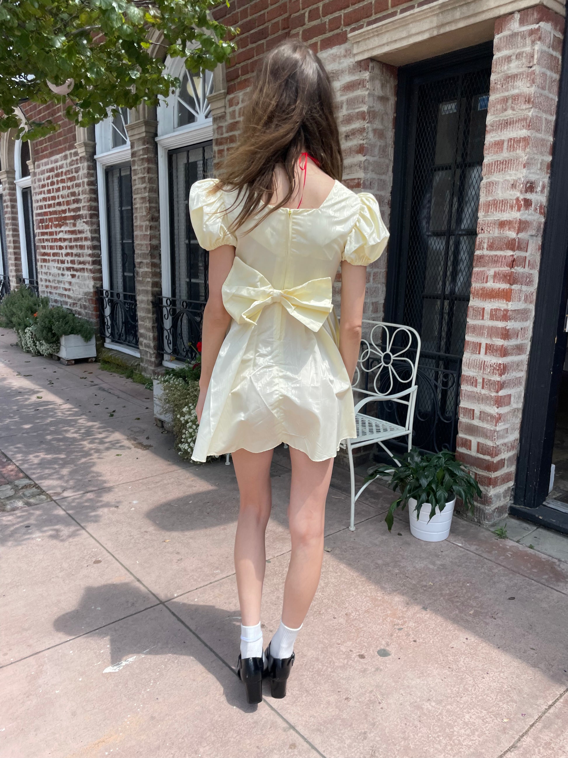 girl wearing yellow short dress