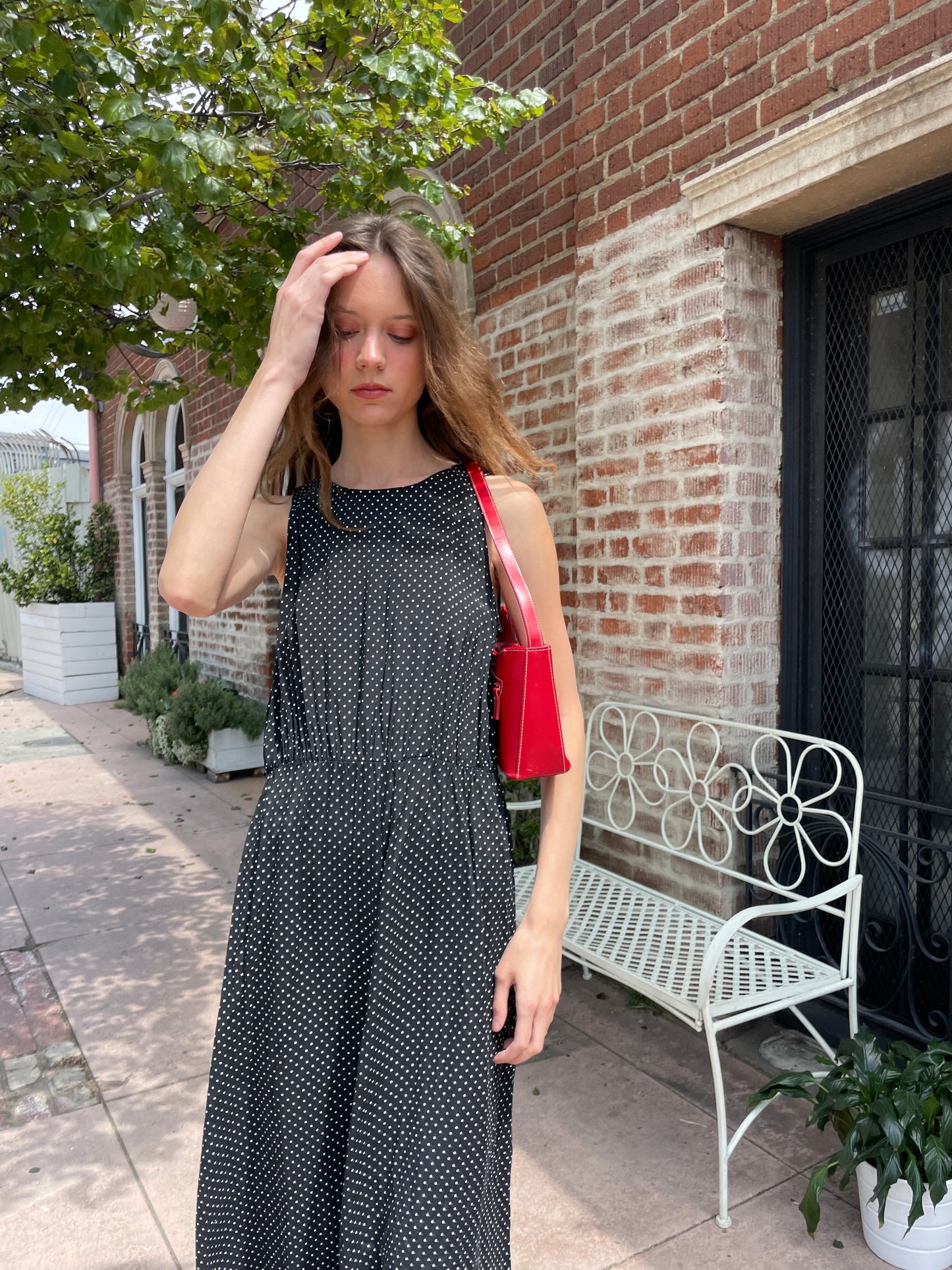 girl wearing black dress and red purse