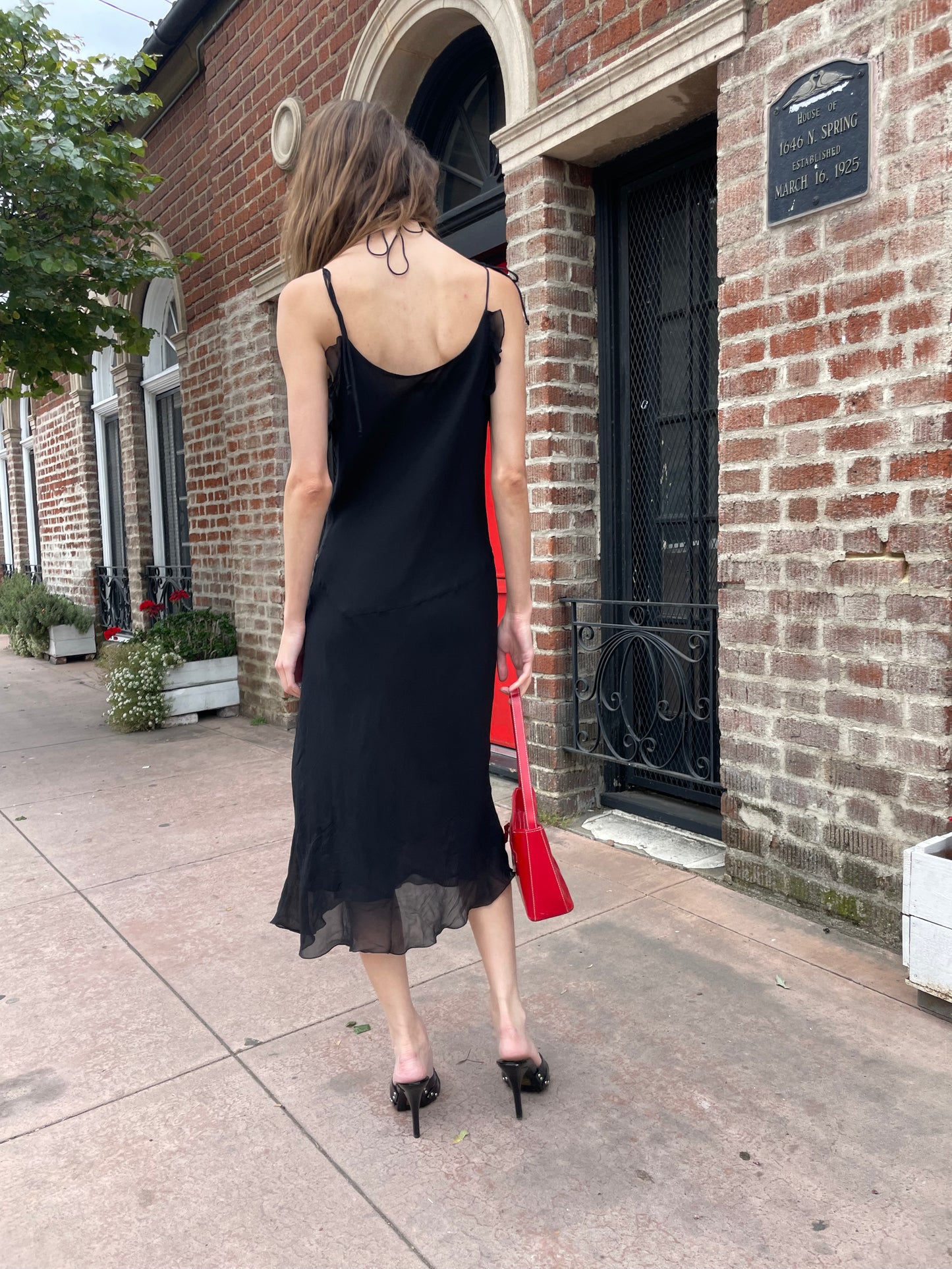 girl in black skinny strap dress
