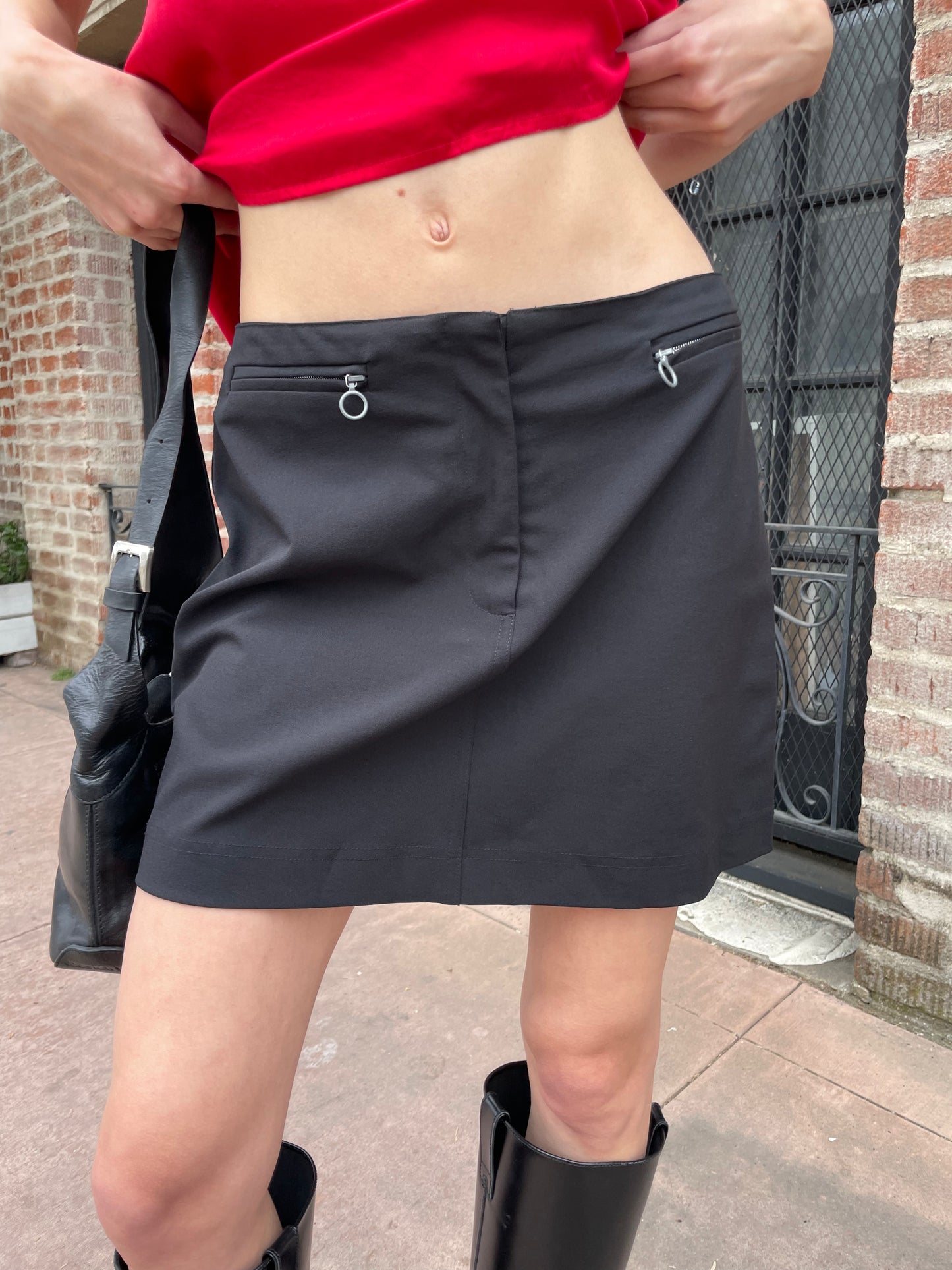 girl in black skirt and red top