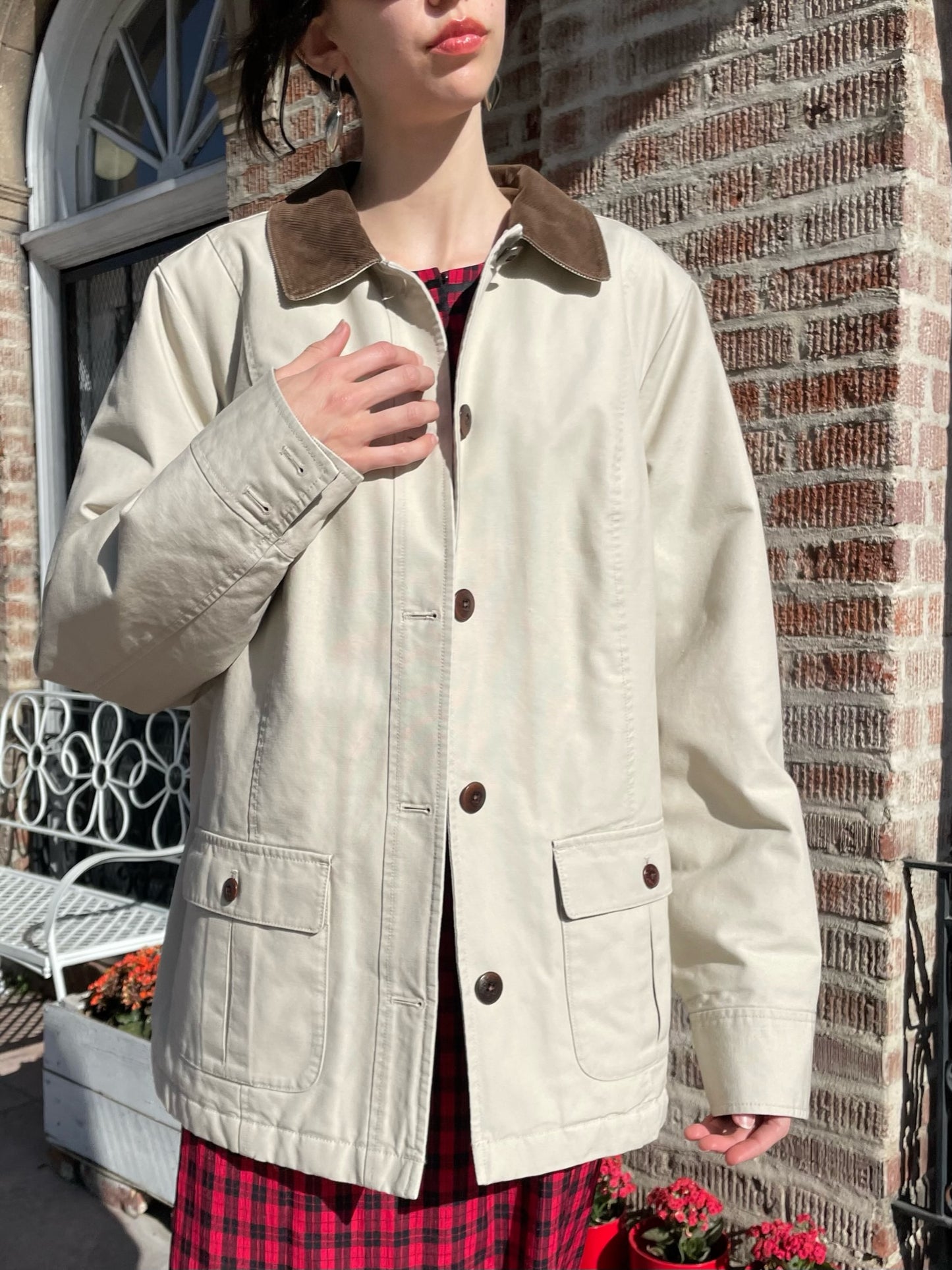 girl wearing a red dress and a tan jacket