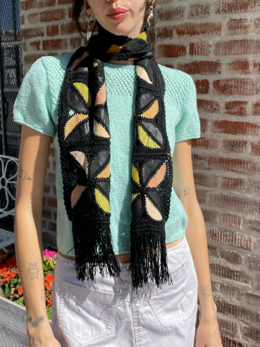 girl wearing blue top, white denim skirt and black scarf
