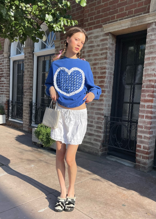 girl in blue sweater and white skirt