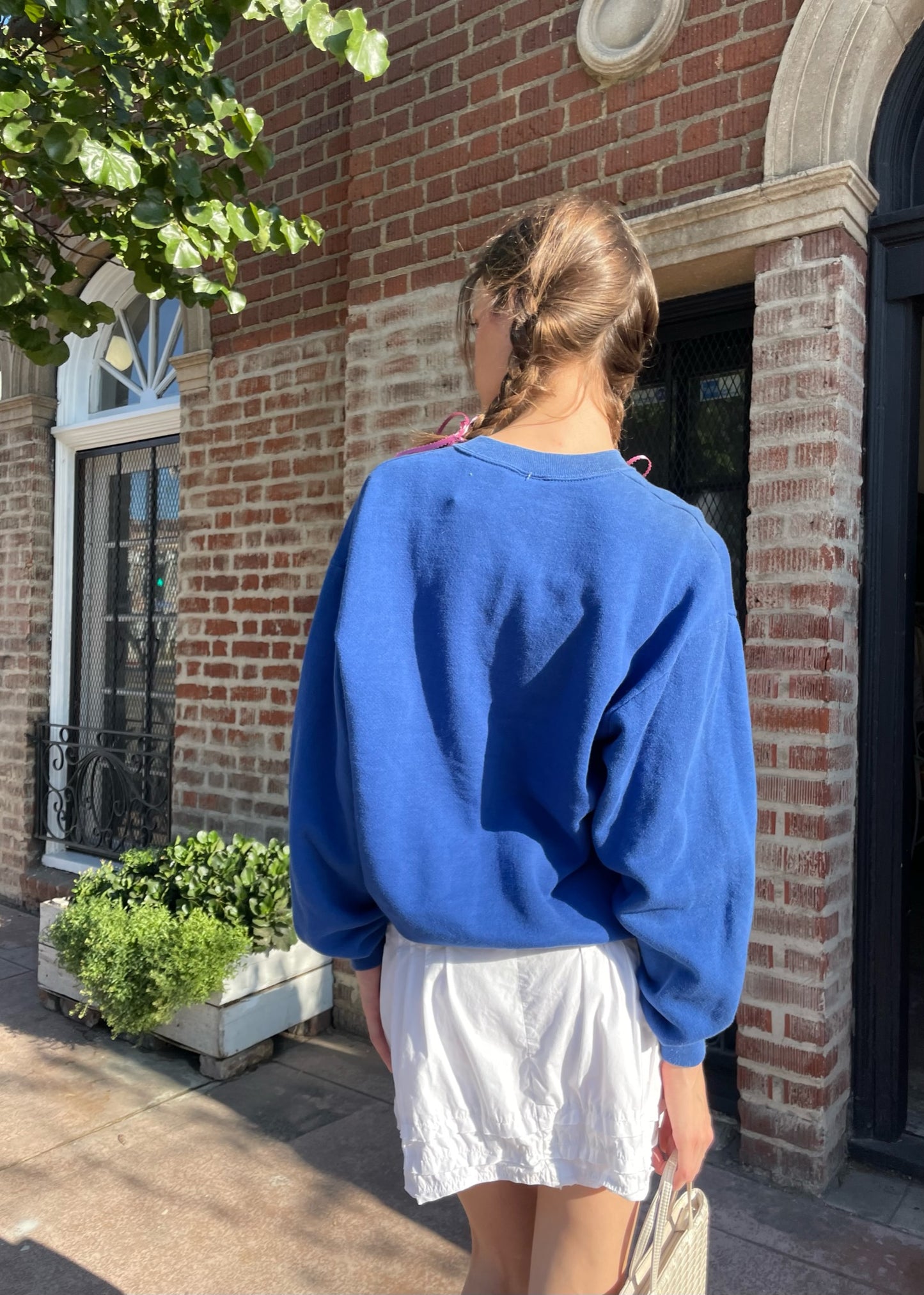 girl in blue sweater and white skirt