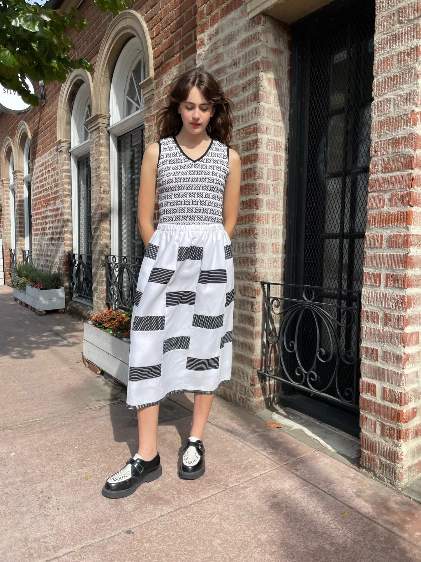 girl wearing black and white shirt and skirt