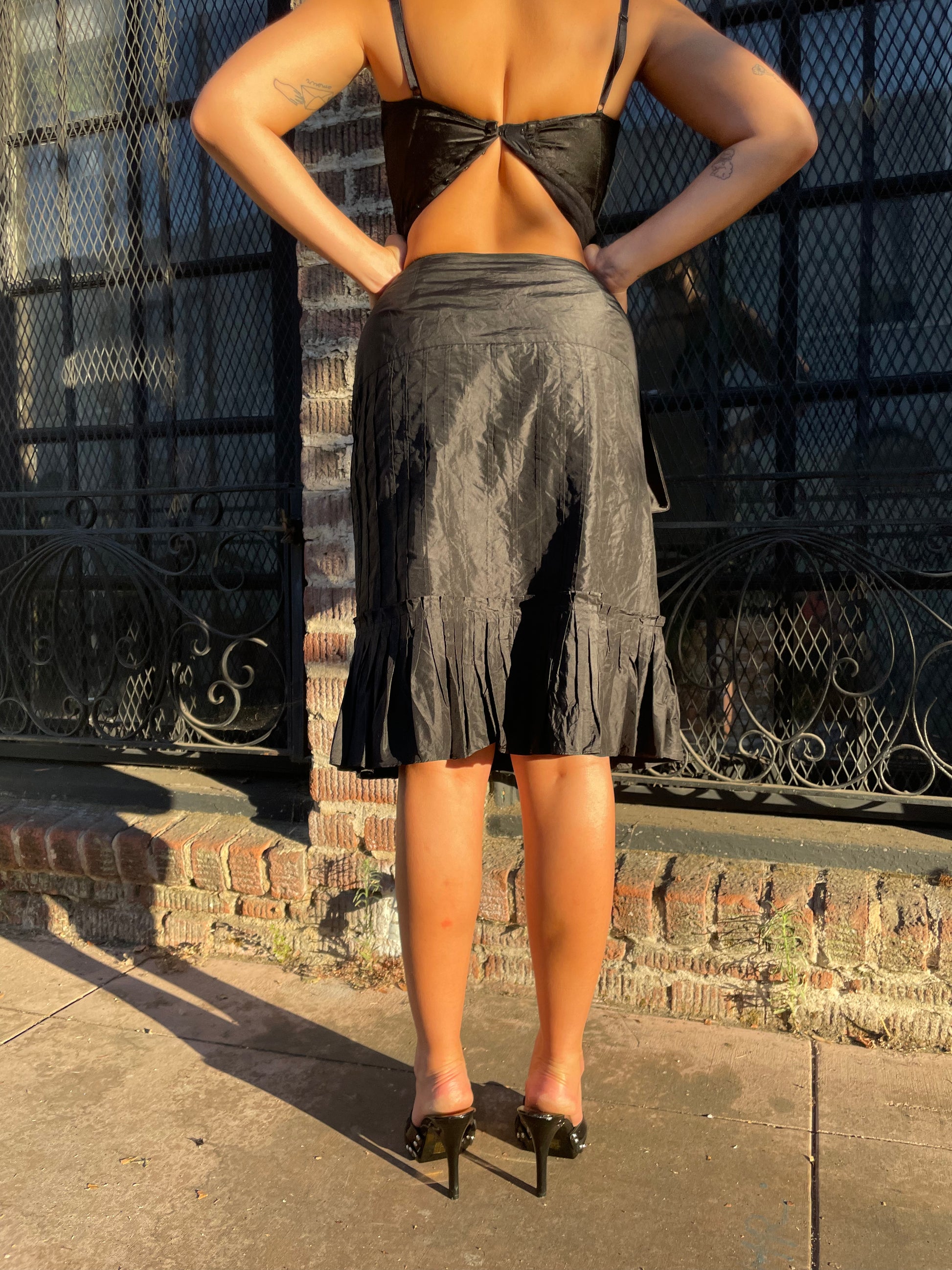 girl in black skirt and black and green top