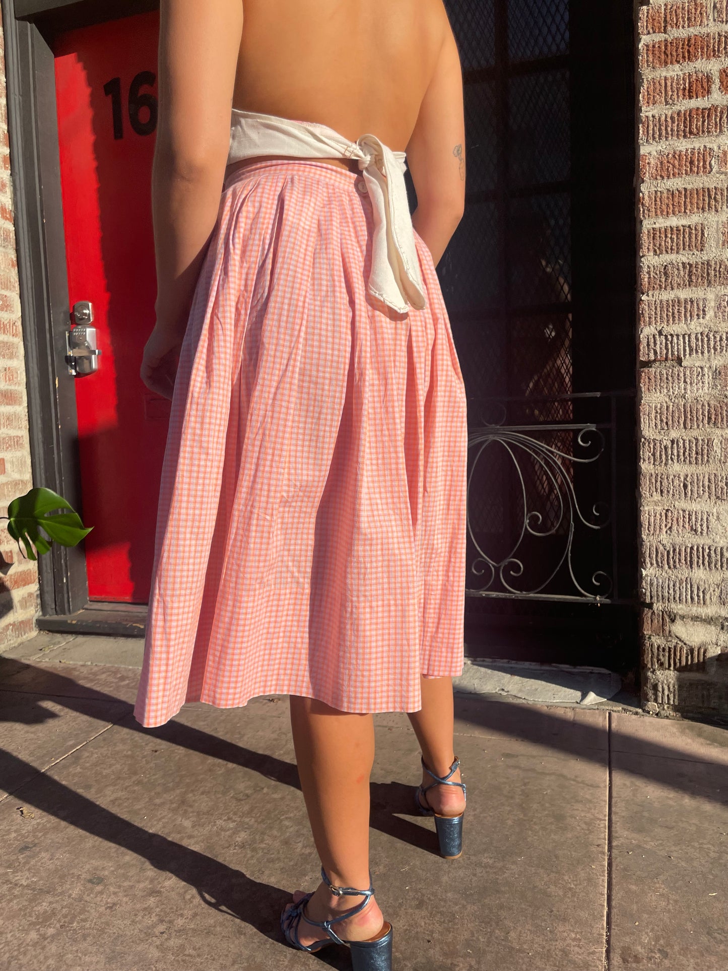 girl in cream halter and pink skirt