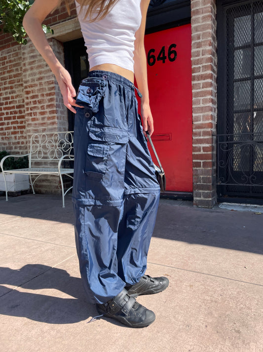 girl in white tank top and blue cargo pants