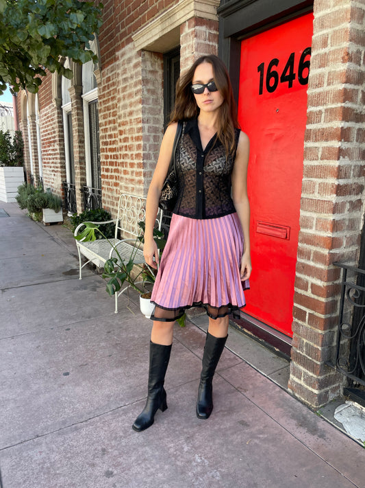 girl in pink satin pleated skirt and black top