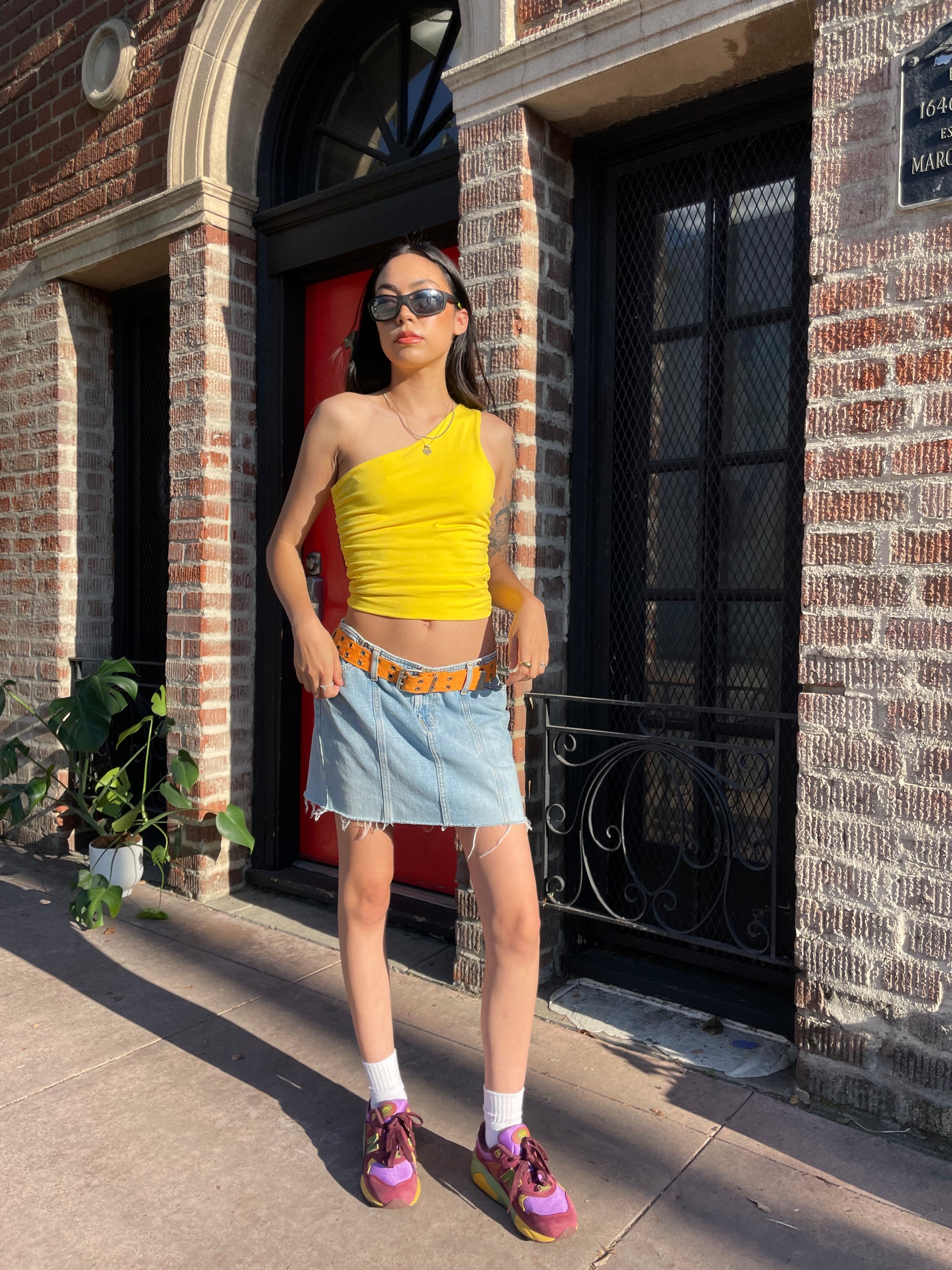 girl in yellow top and denim skirt