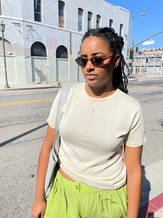 girl wearing beige crew neck blouse