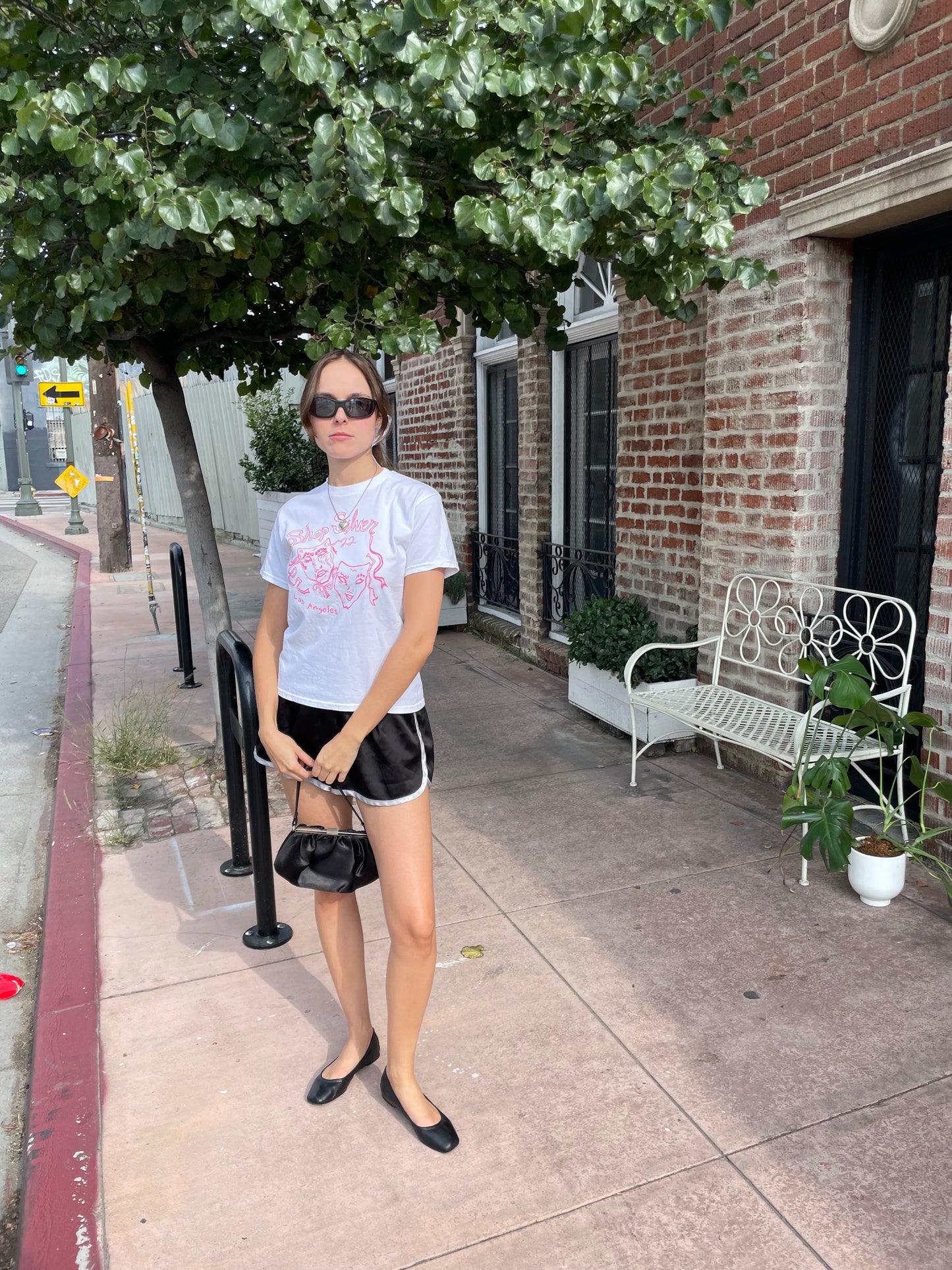 girl in graphic t-shirt and black shorts