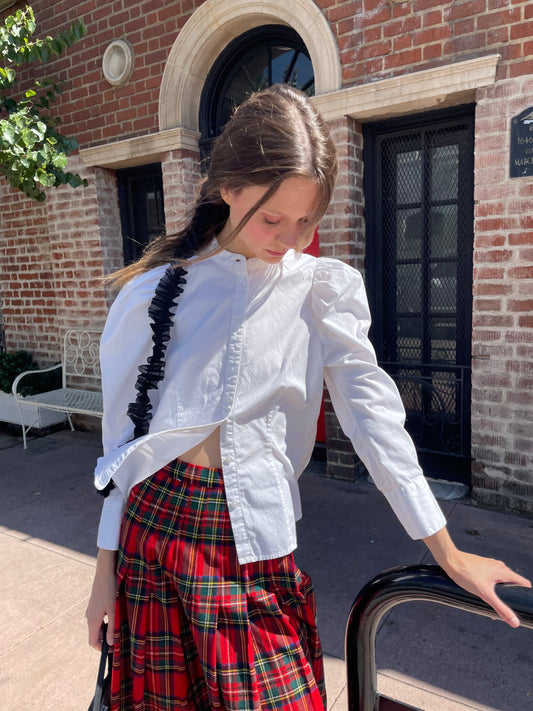 girl in white button down and red plaid skirt