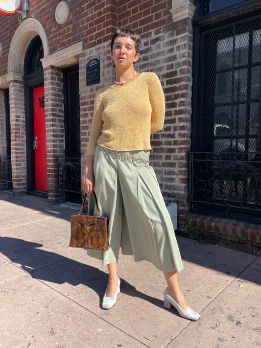 girl wearing yellow top and olive pants