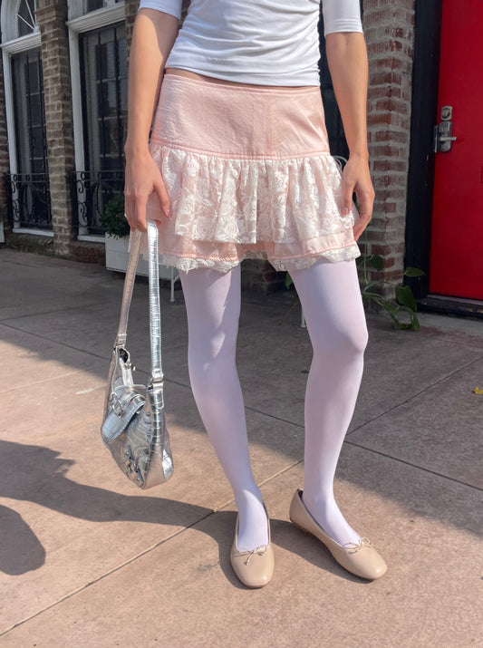 girl in white top and pink skirt