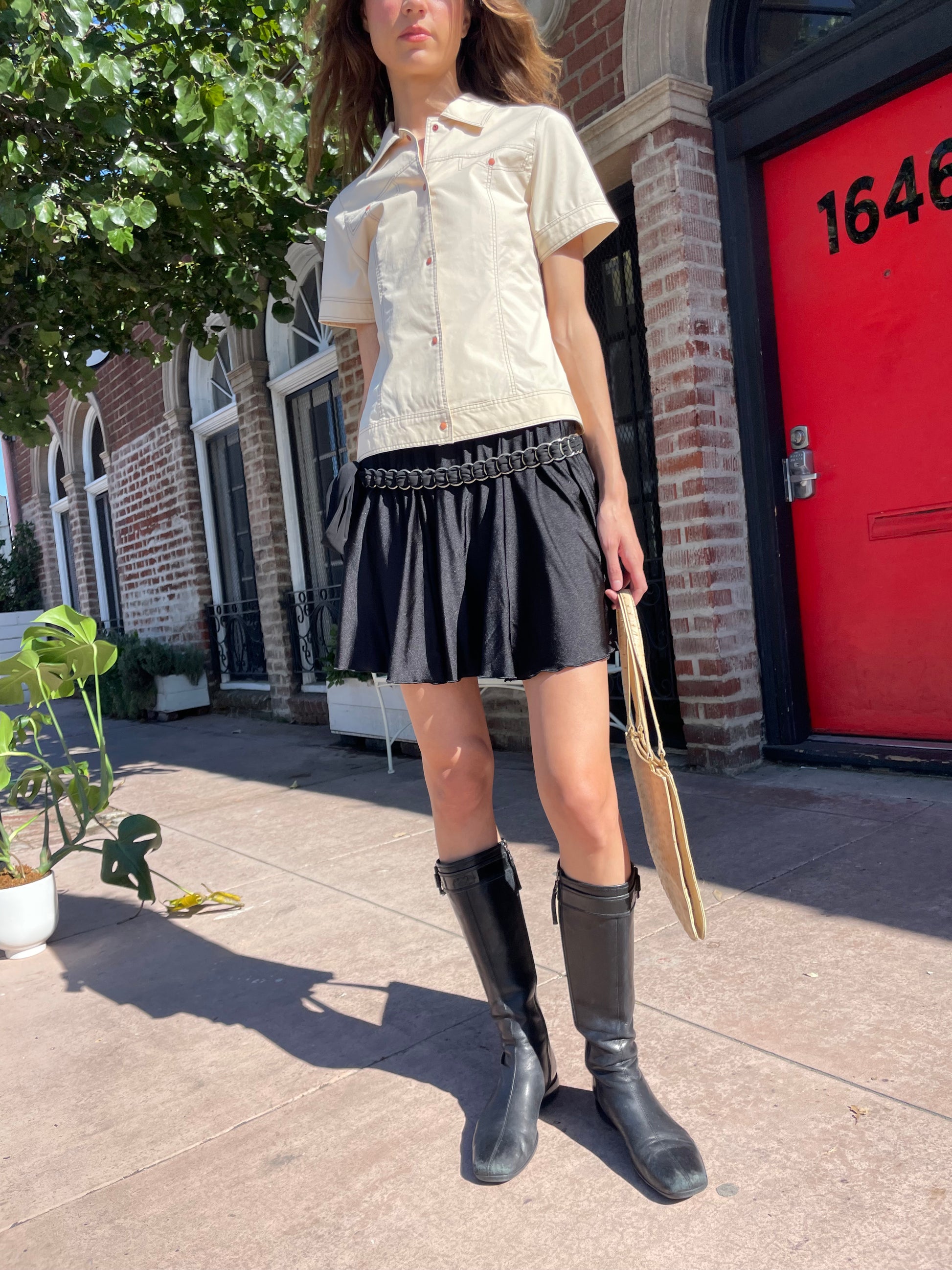 girl in yellow button up and black skirt