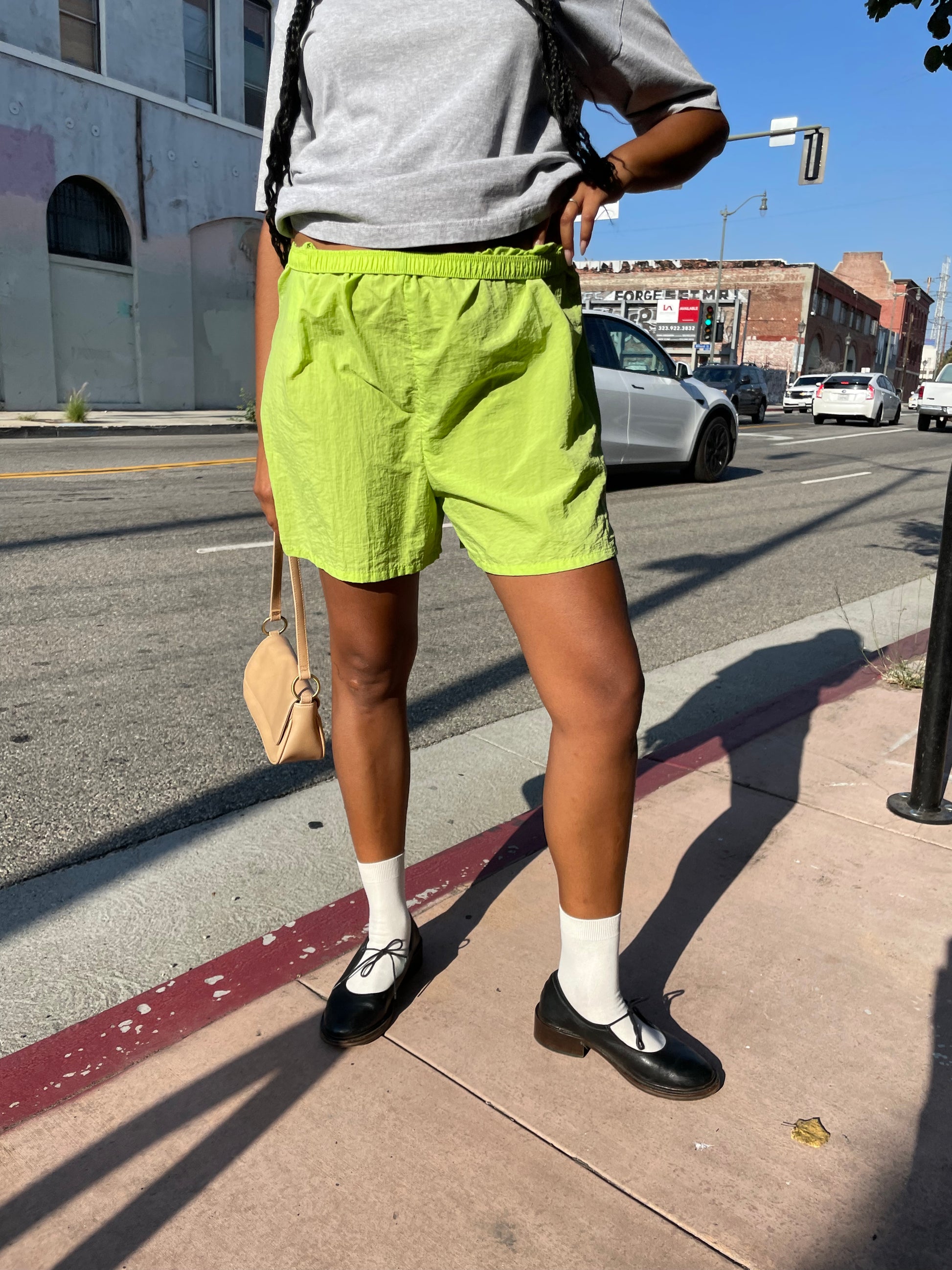 Girl wearing lime green runner shorts