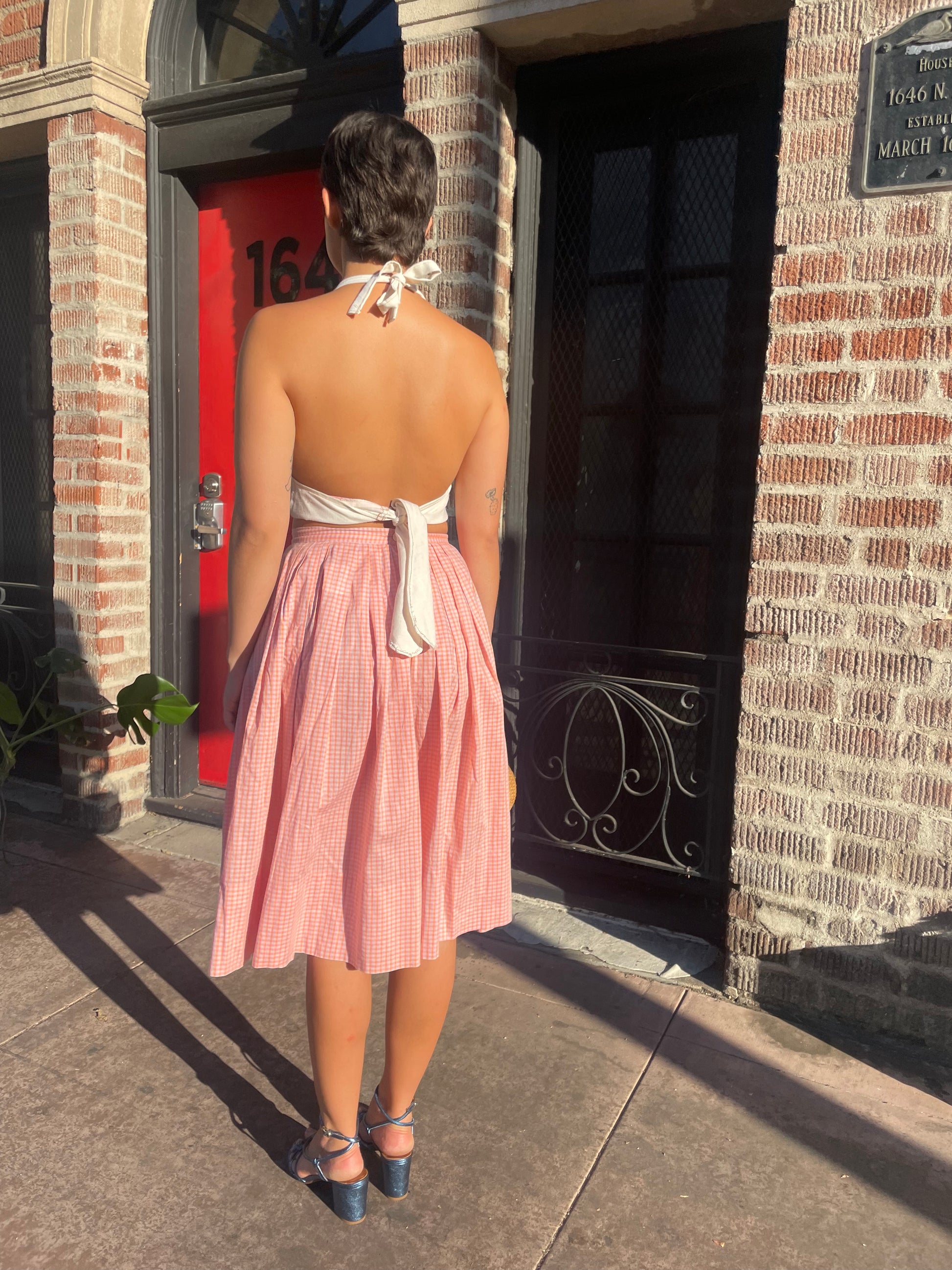 girl in cream halter and pink skirt