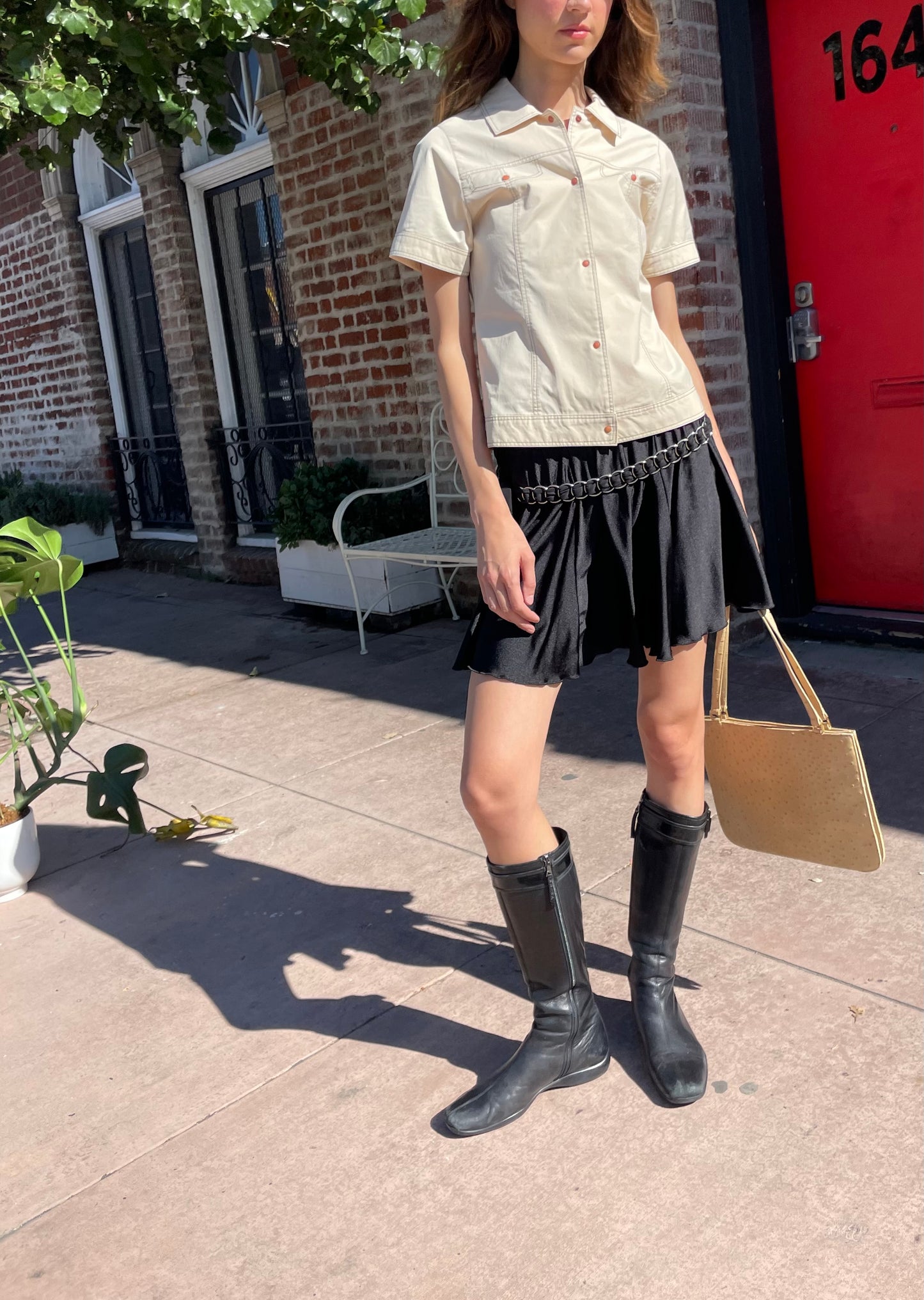 girl in yellow button up and black skirt