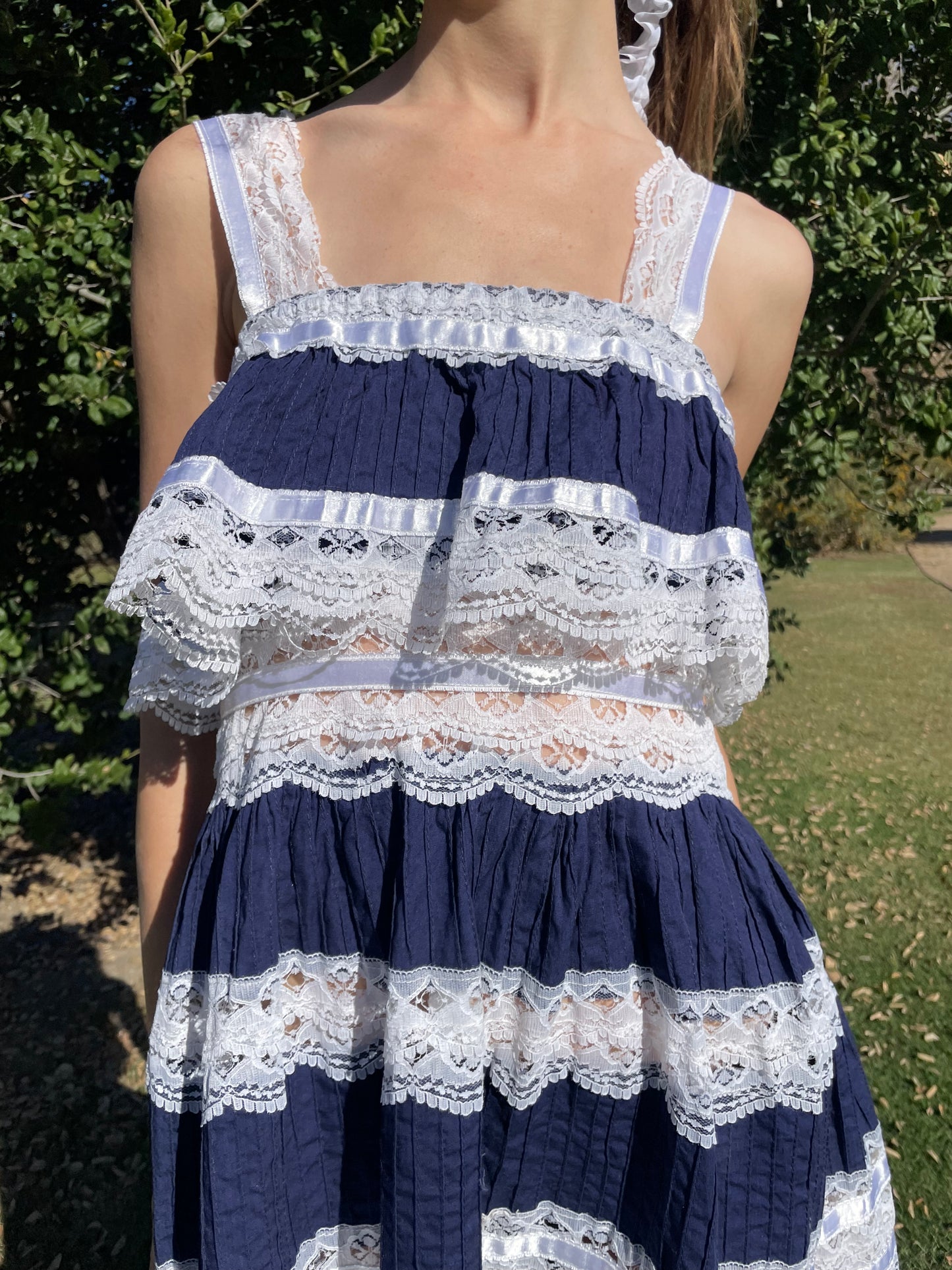 girl in blue and white lace dress