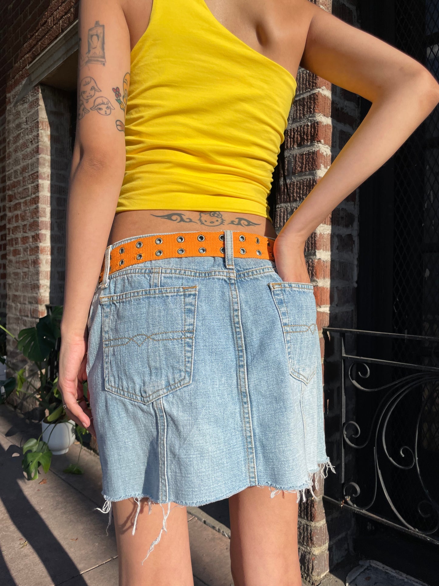 girl in yellow top and denim skirt