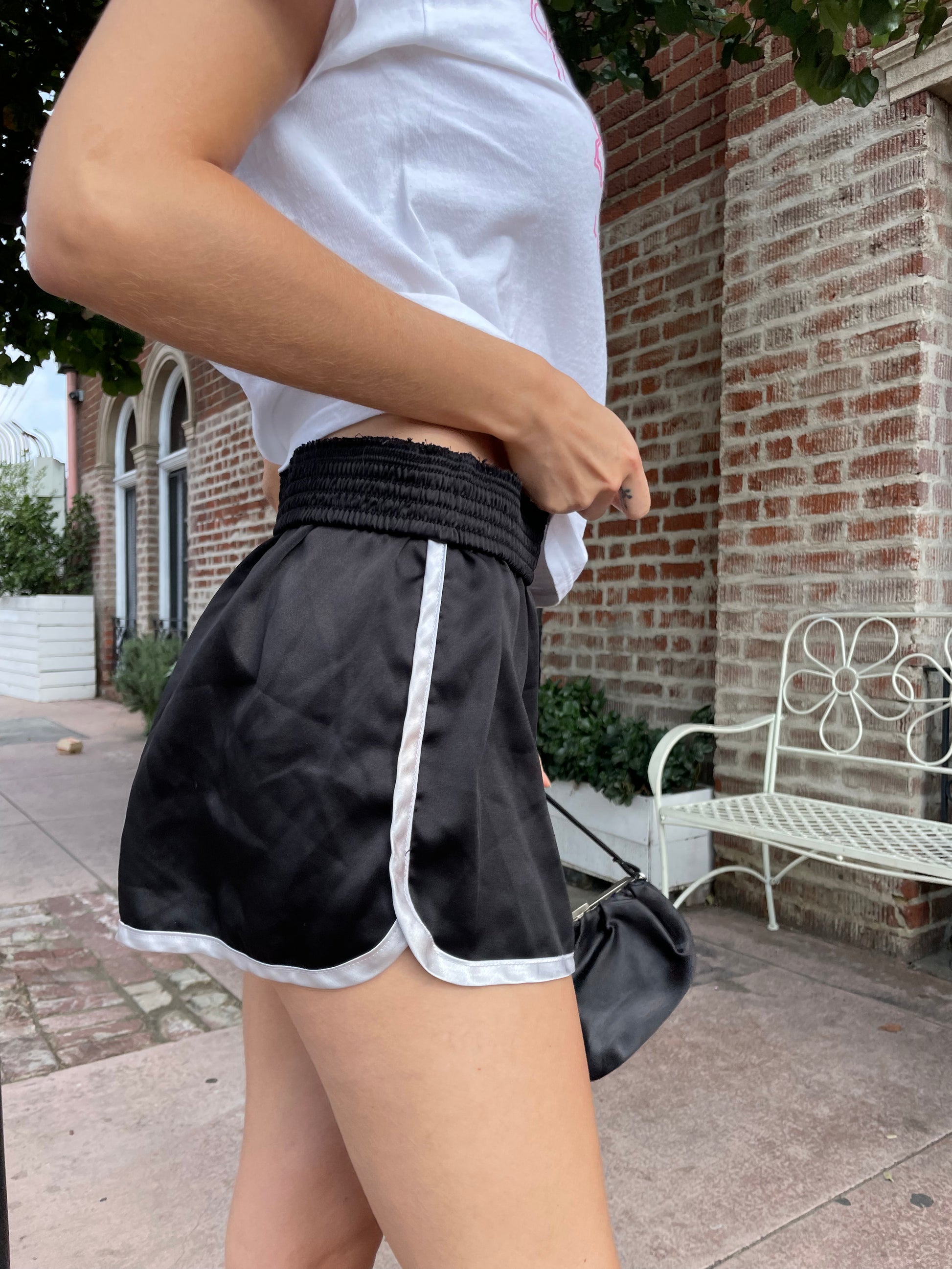 girl in graphic t-shirt and black shorts